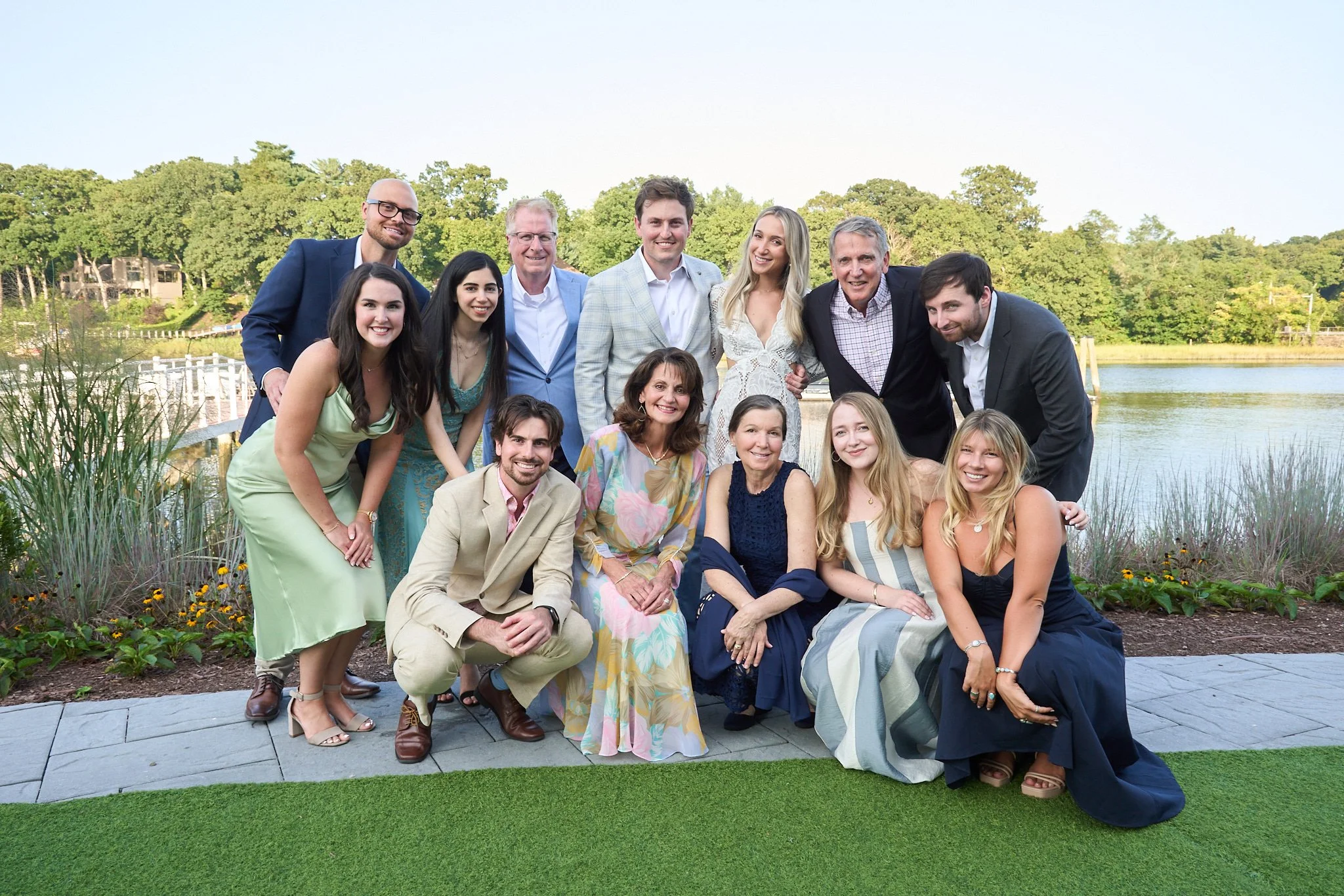 Wedding guests in a group pose at the Saugatuck Rowing Club in Westport, CT, by event photographer Pamela Einarsen