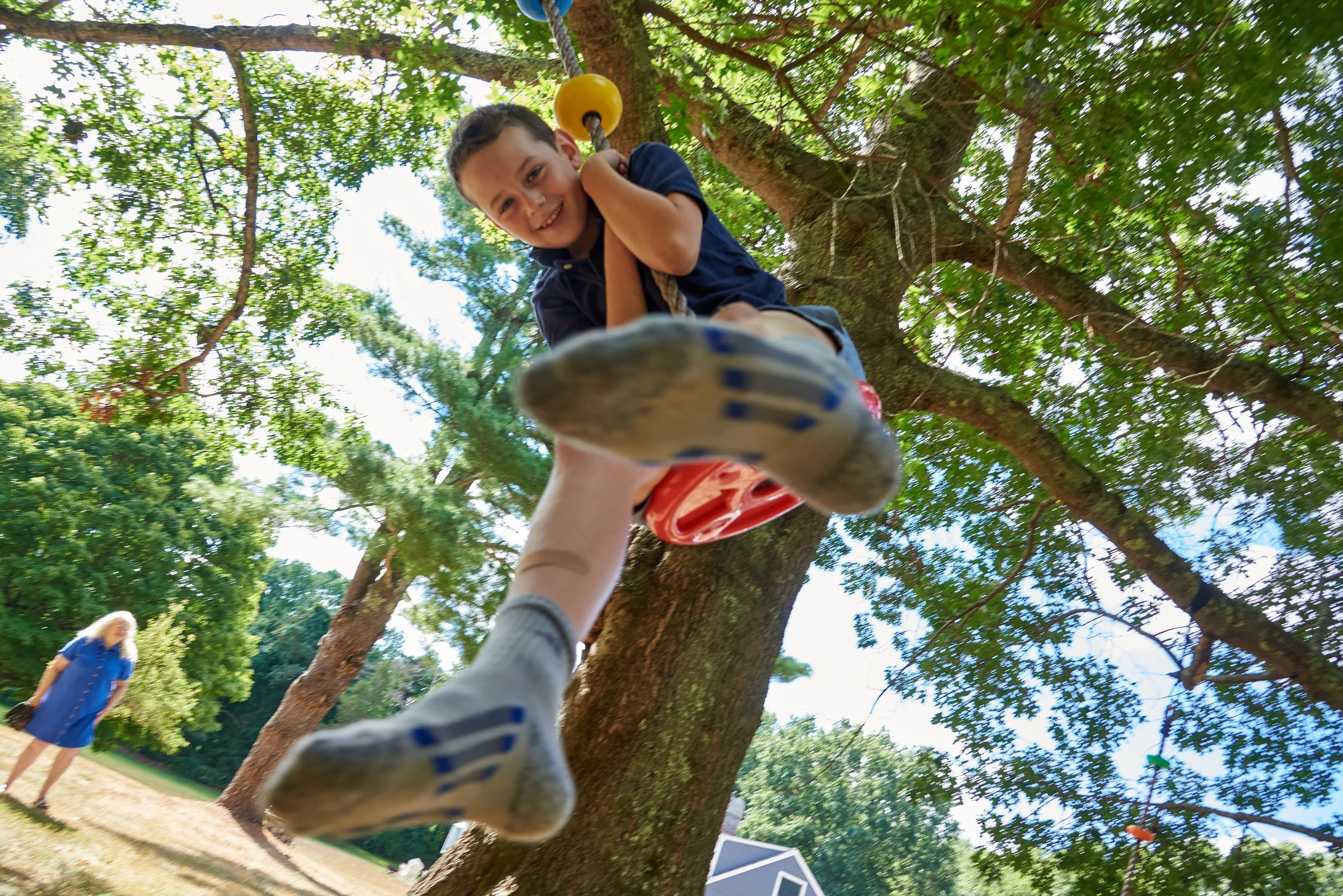 Candid portrait of a boy on a rope swing in Easton, CT by extended family Pamela Einarsen. 
