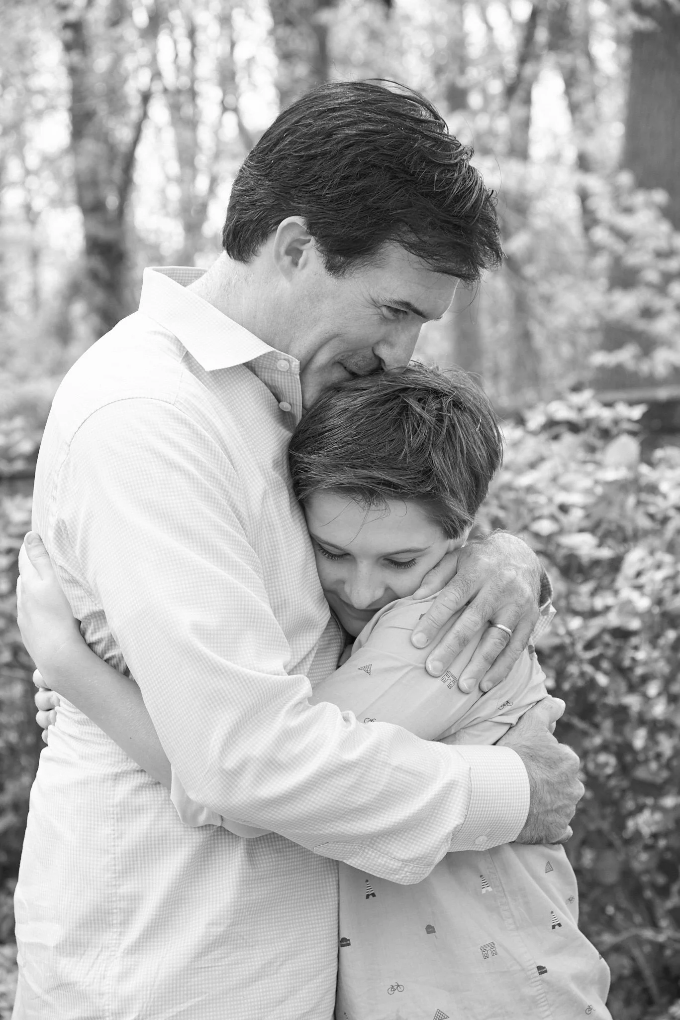 Father hugs his son in B&amp;W family portrait by candid photographer Pamela Einarsen.