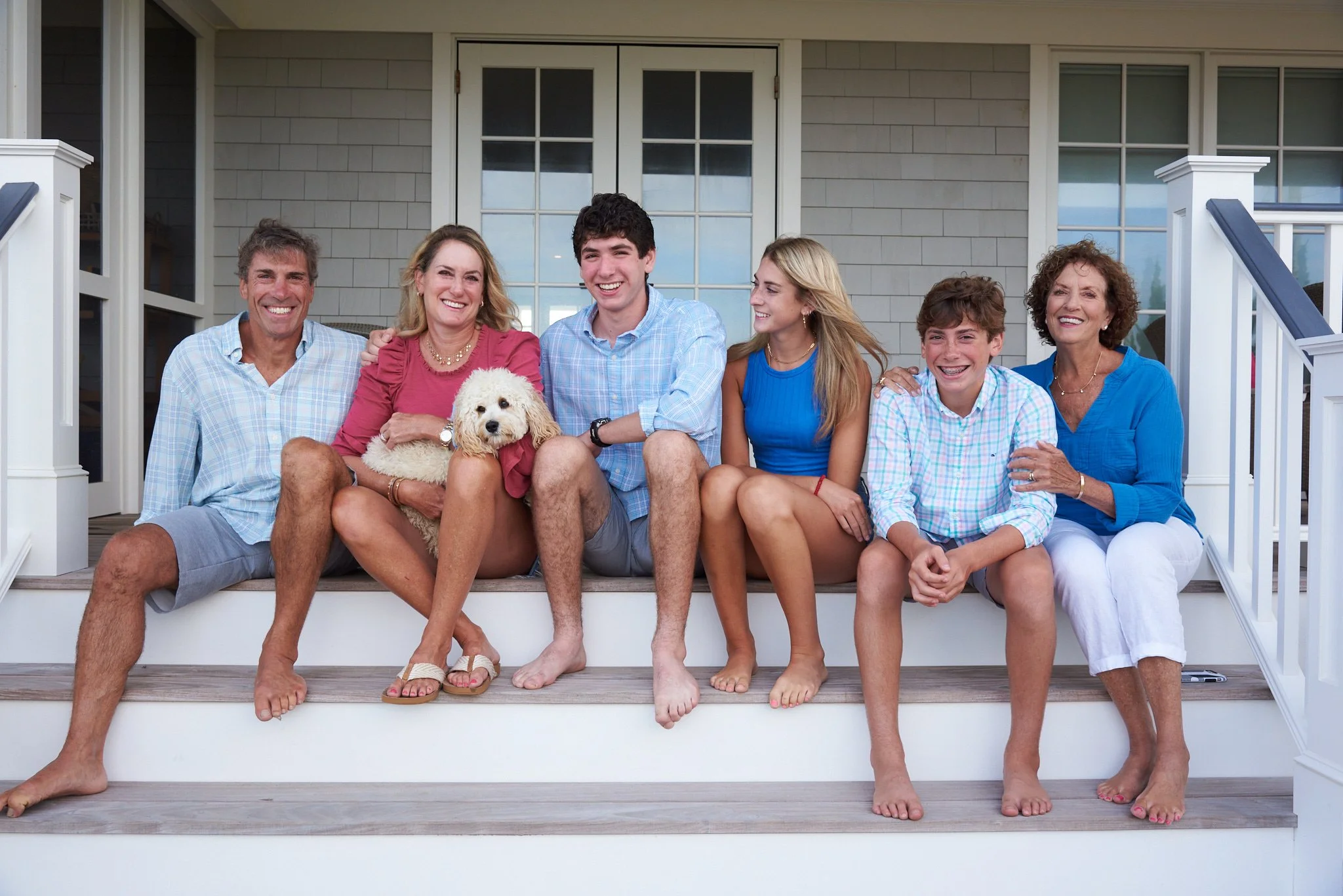 Family poses for a family portrait on the porch of their Jersey Shore house at Point Pleasant  with family photographer Pamela Einarsen. 