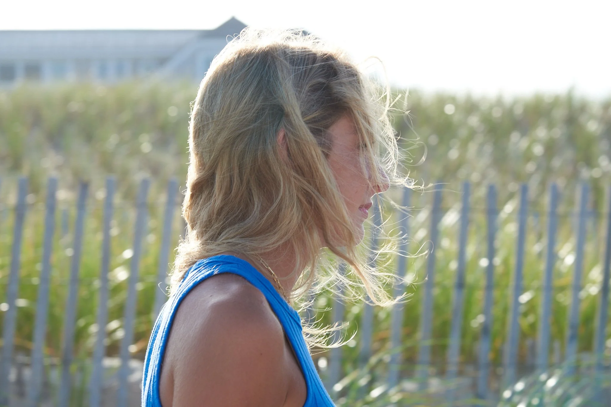 Portrait of girl by the dunes of her Point Pleasant home at the New Jersey Shore.