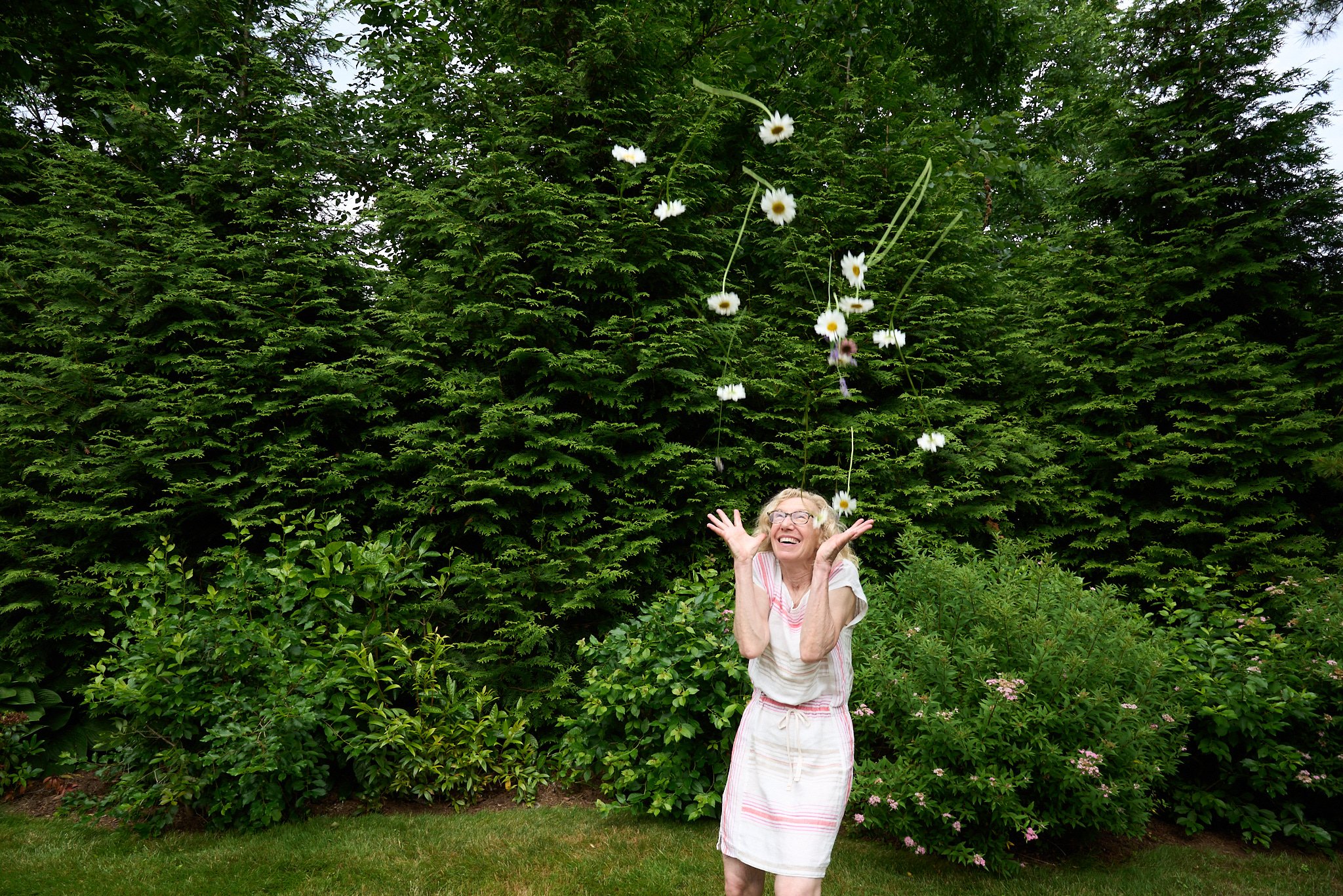 Woman throws flowers in the air by lifestyle photographer Pamela Einarsen.  (Copy)