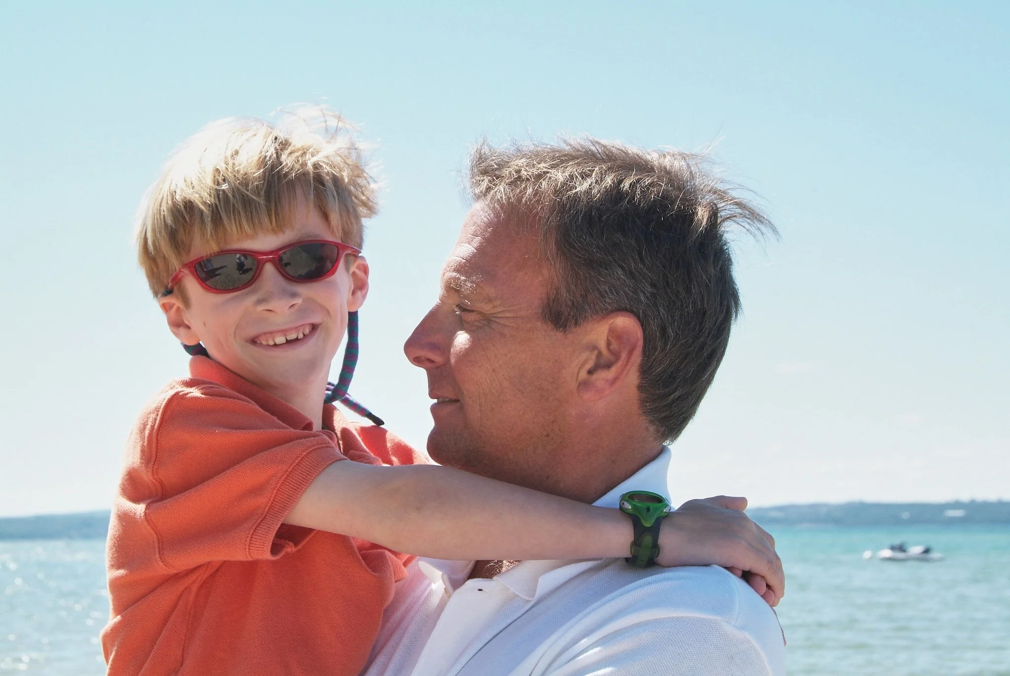 Father and son at beach on Lake Michigan by family photographer Pamela Einarsen.