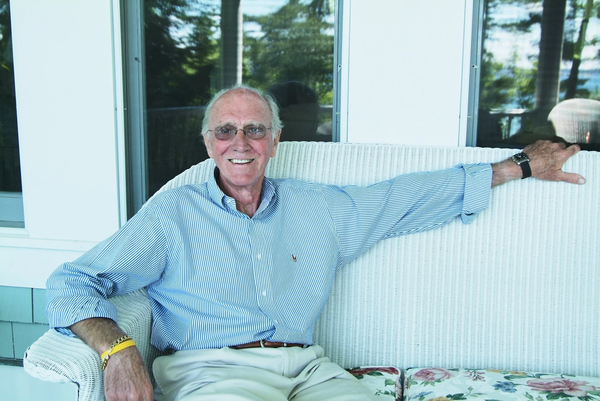 Grandfather celebrates a milestone birthday on a porch near Harbor Springs, MI by extended family photographer Pamela Einarsen.