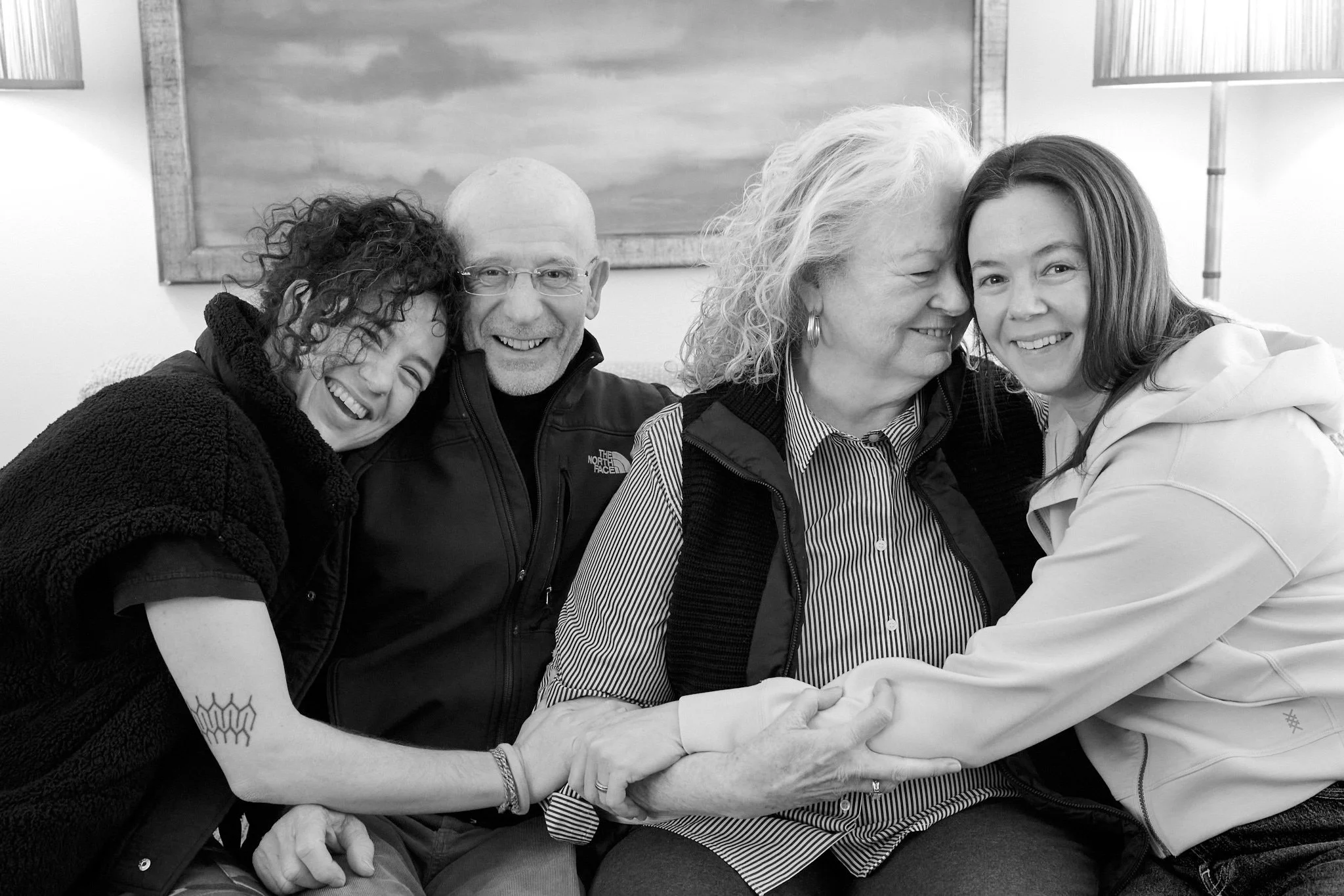Family hugs on couch of their Easton, CT home in family session with photographer Pamela Einarsen. 