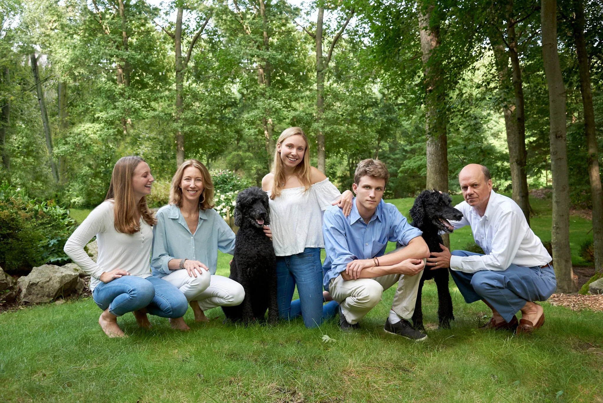 Family poses with their dogs in Darien, CT by family photographer Pamela Einarsen.