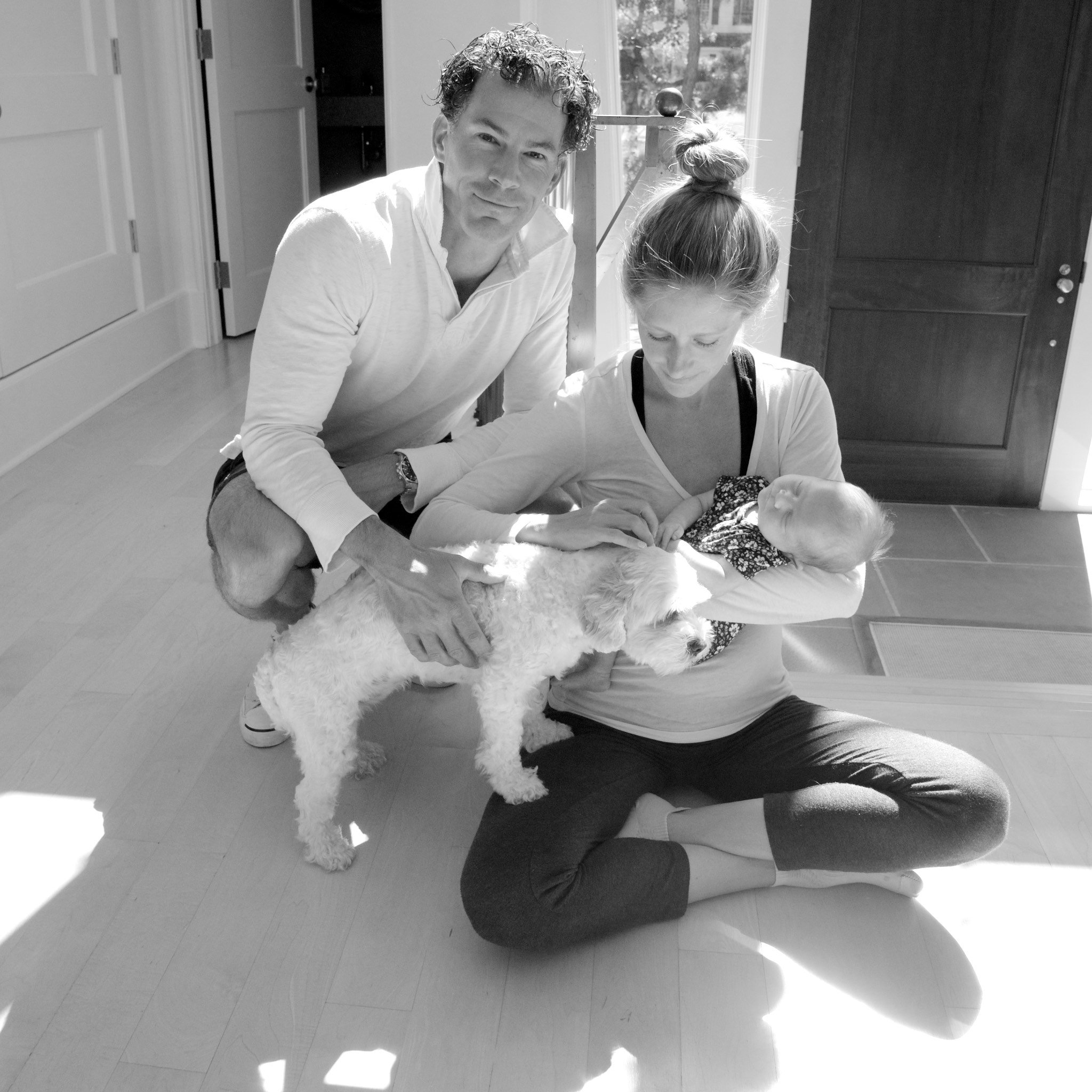 Mom and dad with new baby and dog in their Rowayton, CT home with baby photographer Pamela Einarsen. 