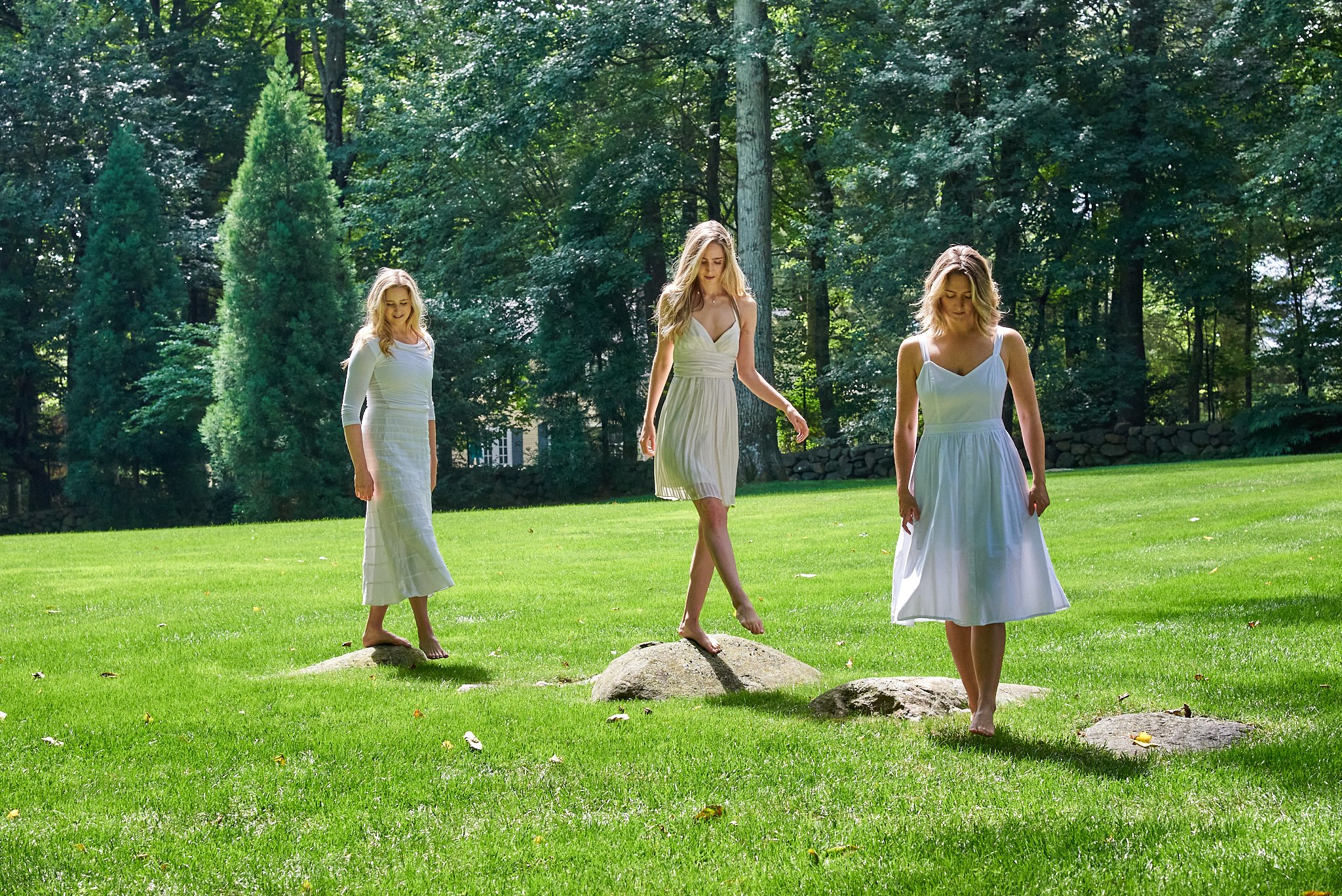 sisters walk in their yard in Greenwich, CT with lifestyle photographer Pamela Einarsen. 