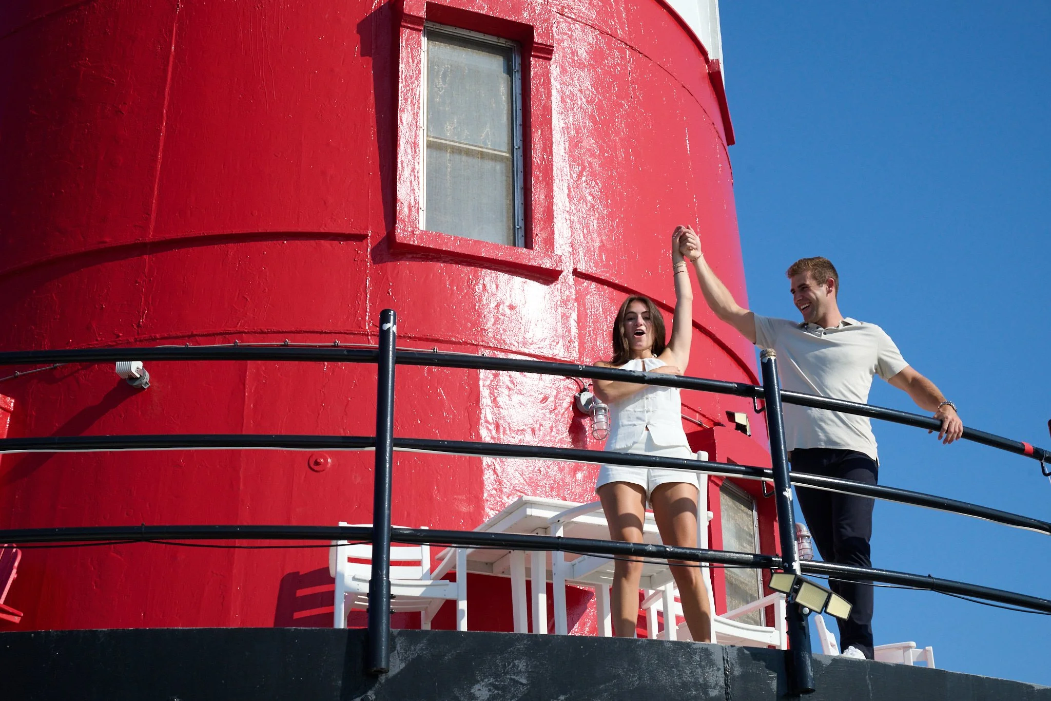 Couple celebrate on Greens Ledge Lighthouse after proposal with photographer Pamela Einarsen in Rowayton CT.