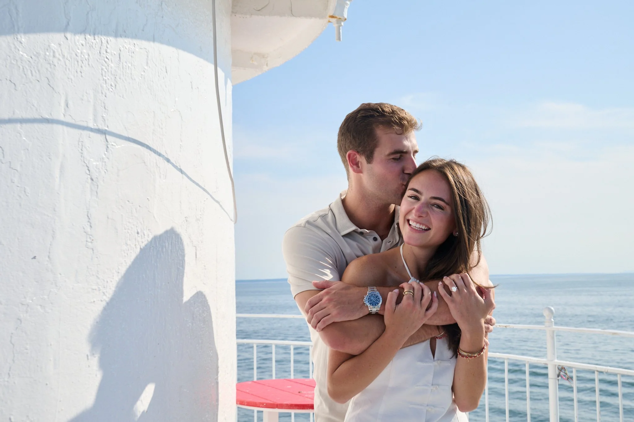 Engagement photo of couple after proposal on Green Ledge Lighthouse in Rowayton CT by photographer Pamela Einarsen. 