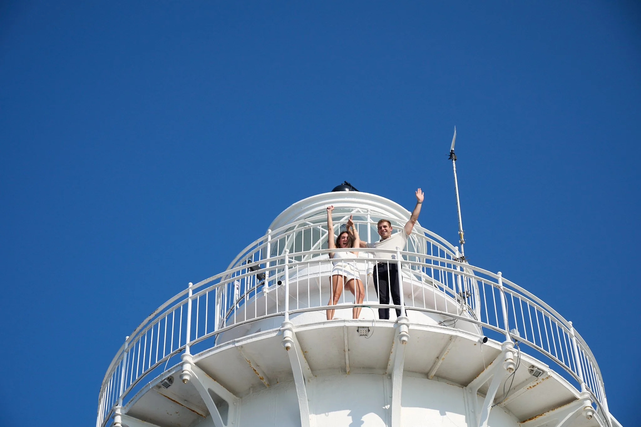 Couple celebrate after proposal on the Green Ledge Lighthouse in Rowayton CT by photographer Pamela Einarsen. 