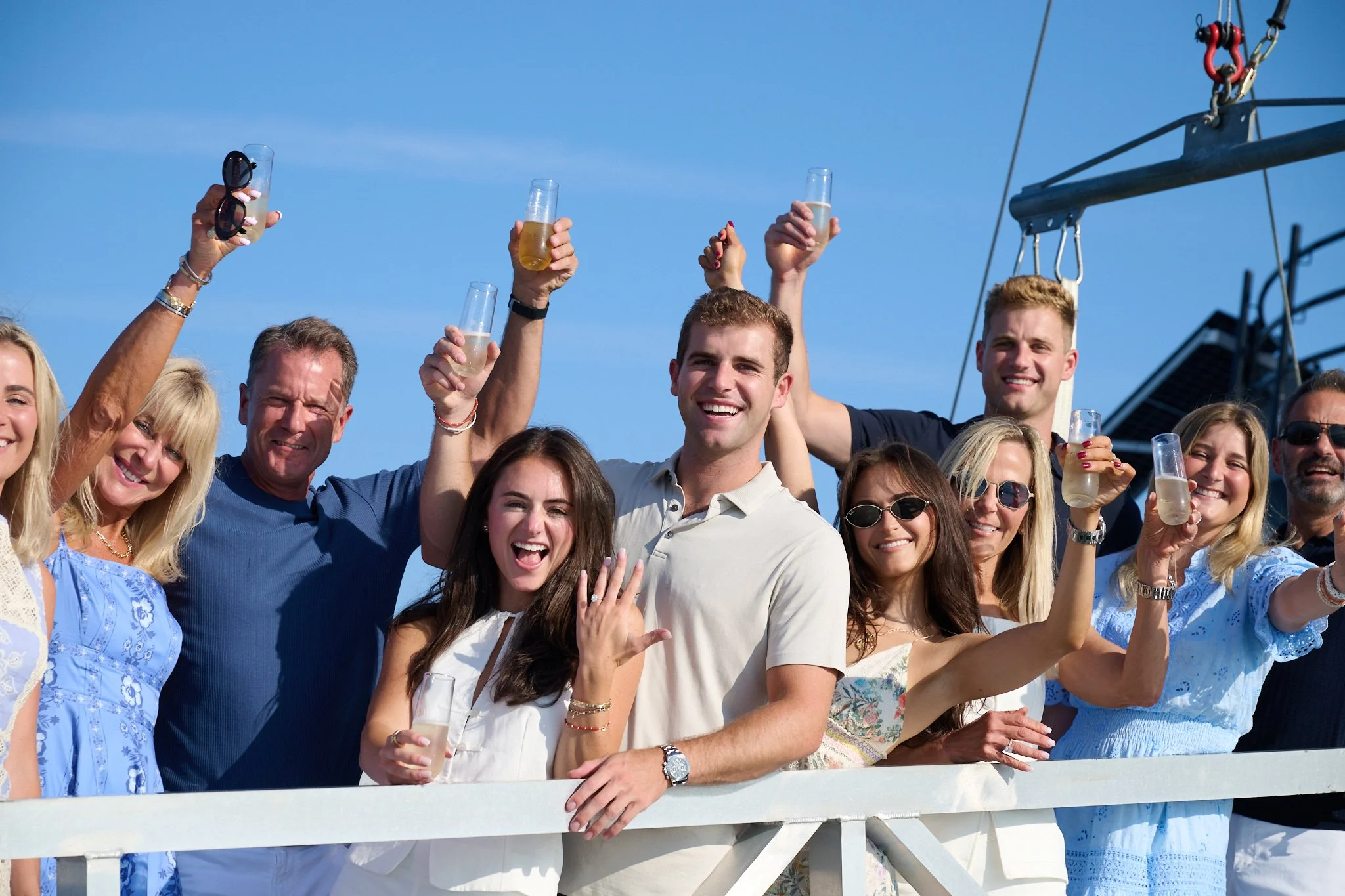 Family toasts on the dock at Green Ledge Lighthouse in Rowayton CT by proposal photographer Pamela Einarsen. 