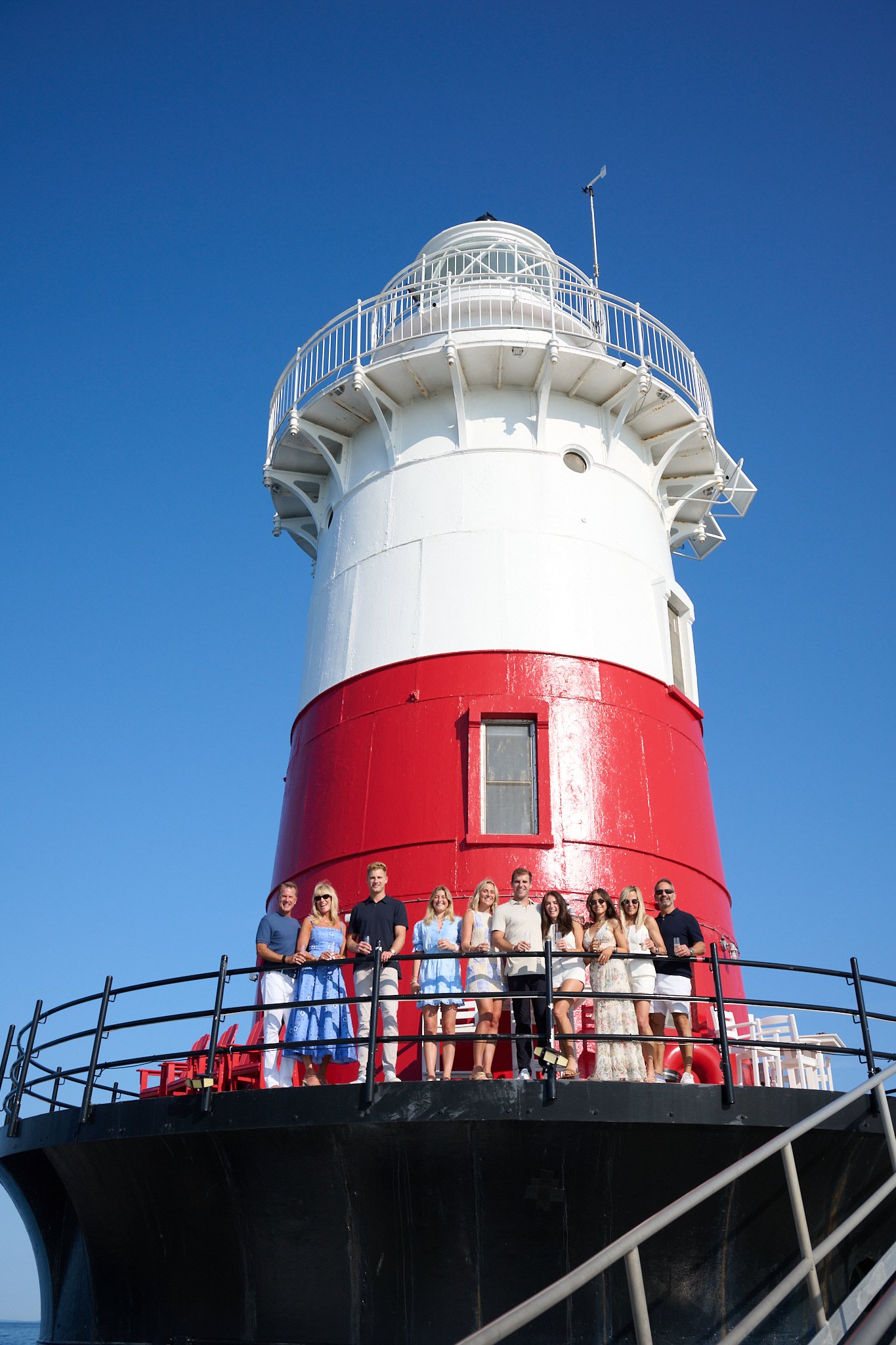Family stands by Green Ledge Lighthouse in Rowayton CT after proposal by photographer Pamela Einarsen, 