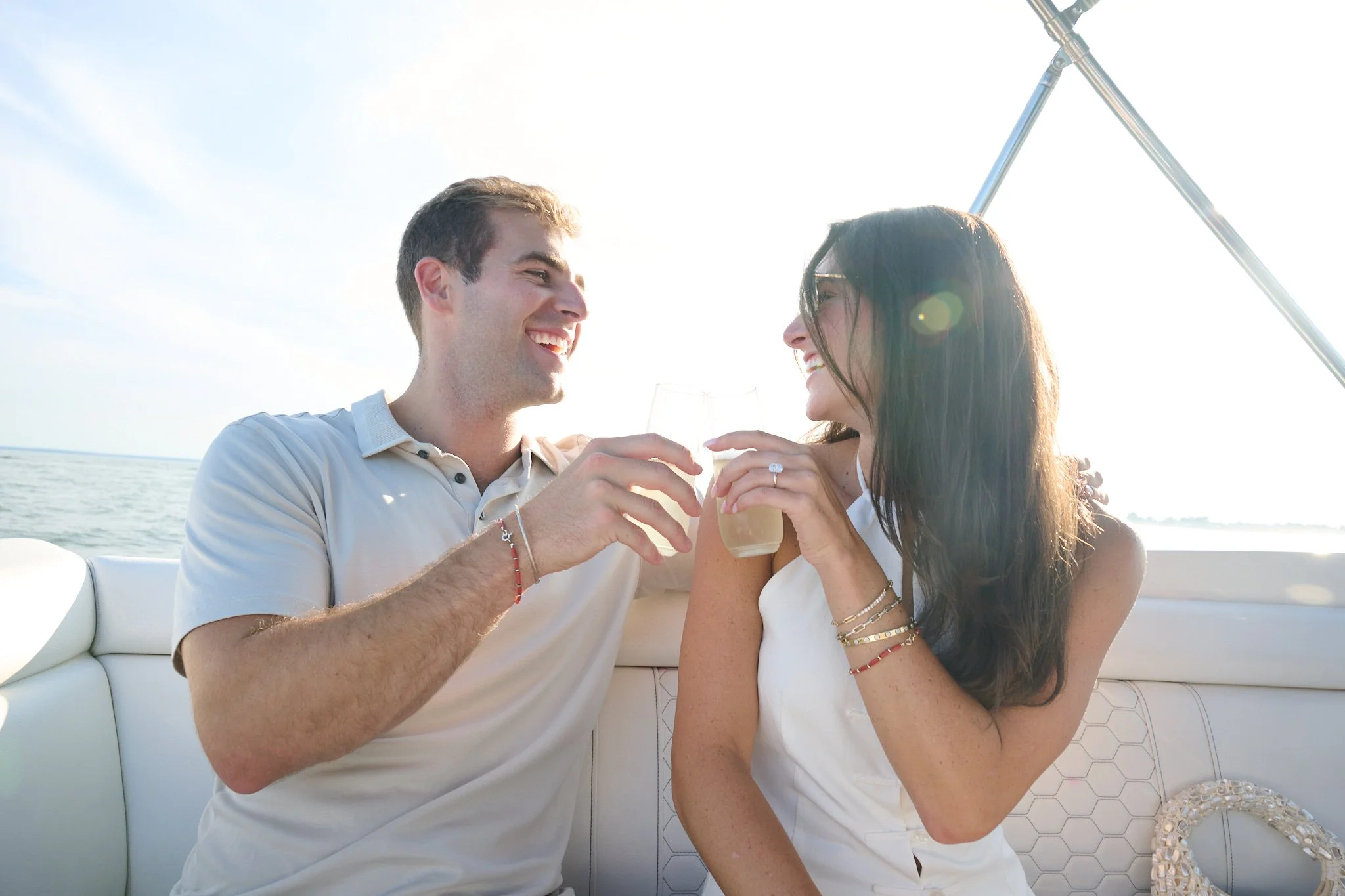Couple toast champagne after a proposal on the Green Ledge Lighthouse in Rowayton CT by photographer Pamela Einarsen. 