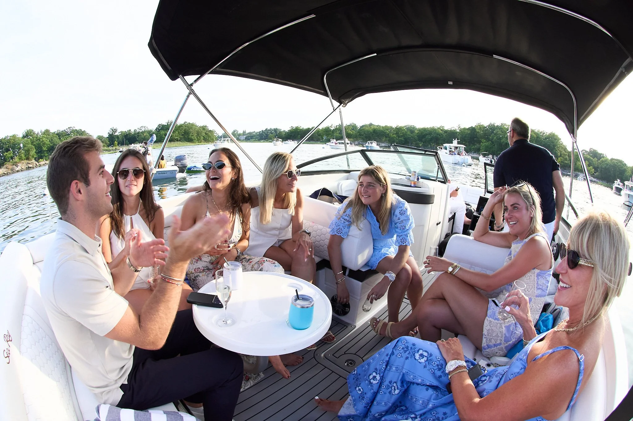 Family celebrates on boat after proposal on Green Ledge Lighthouse in Rowayton CT with photographer Pamela Einarsen.