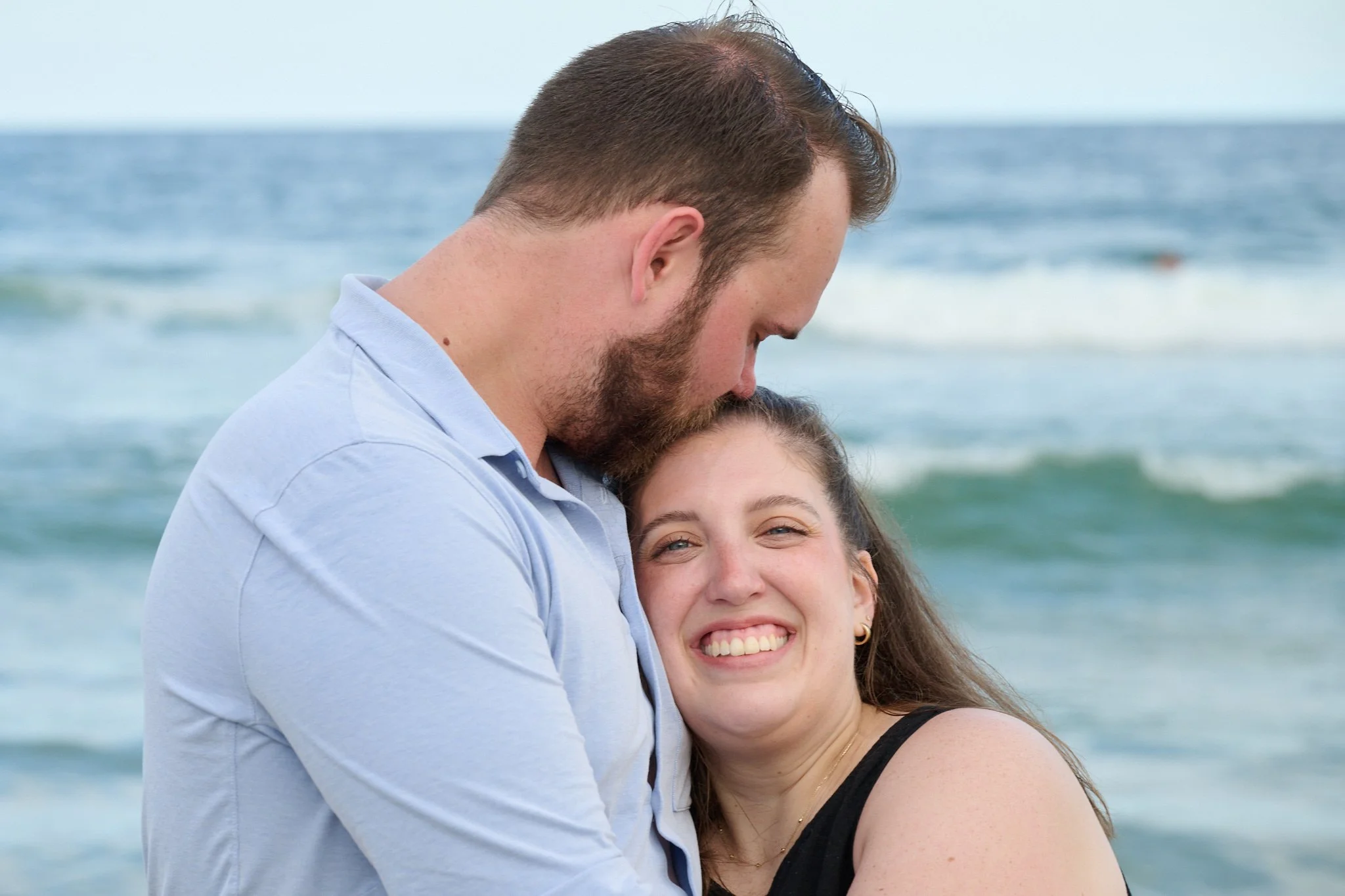 Man kisses woman on the beach on Long Beach Island with photographer Pamela Einarsen.