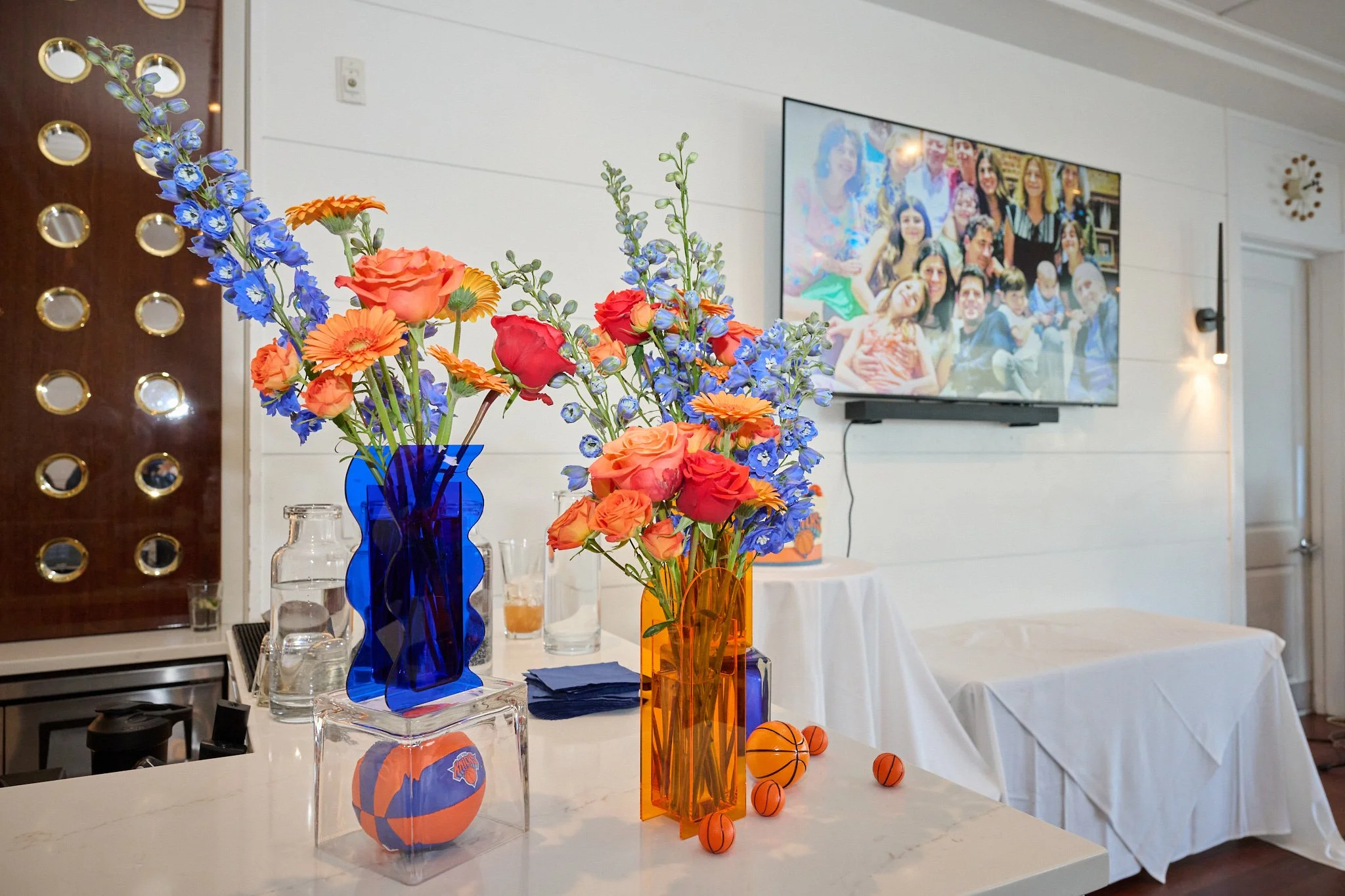 Knicks colored flowers and decorations at the Boathouse Restaurant  in Westport, CT with Bar Mitzvah photographer Pamela Einarsen.