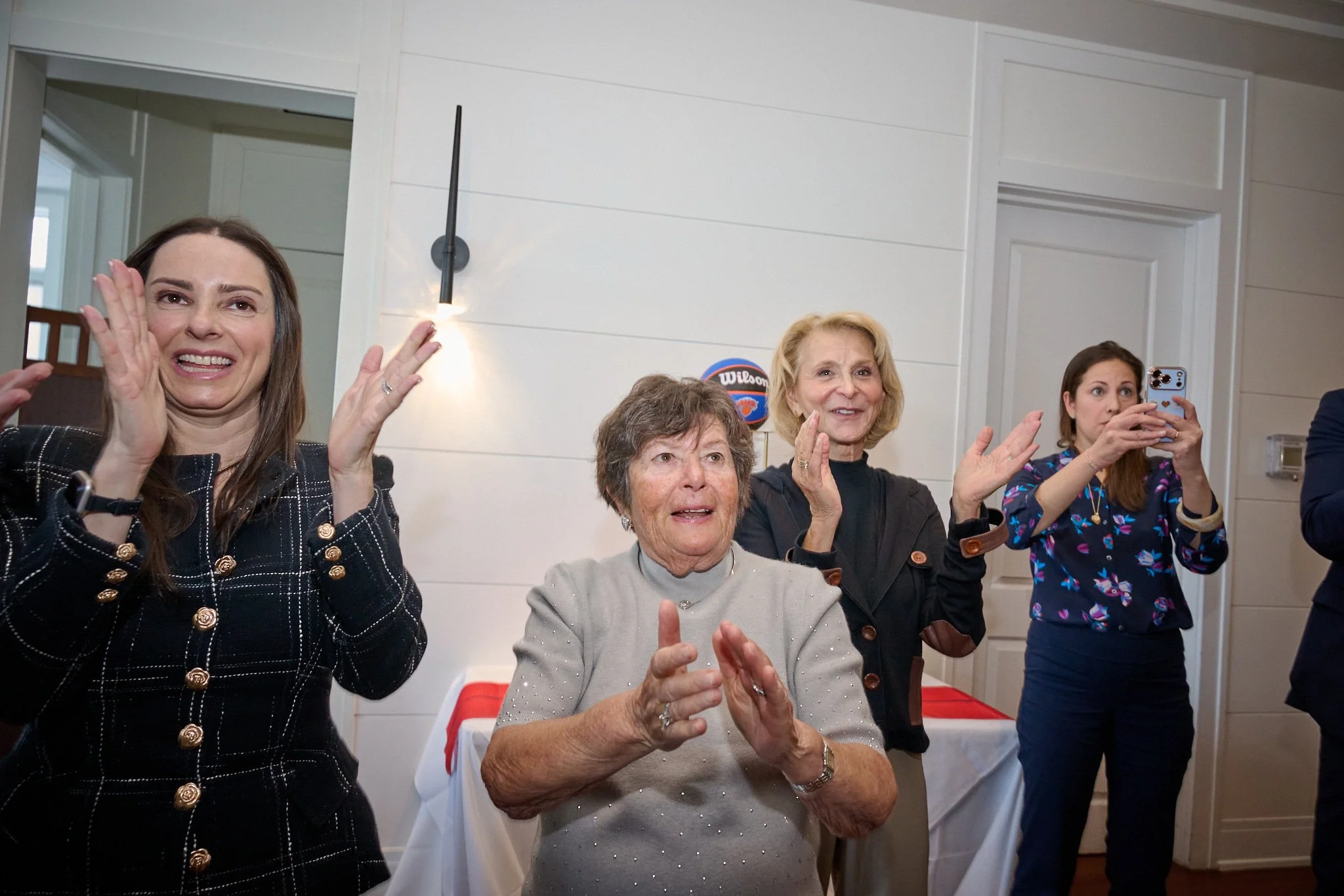 Family claps and cheers for bar mitzvah boy at the Rowing Club Boathouse Restaurant in Westport, CT by even photographer Pamela Einarsen. 