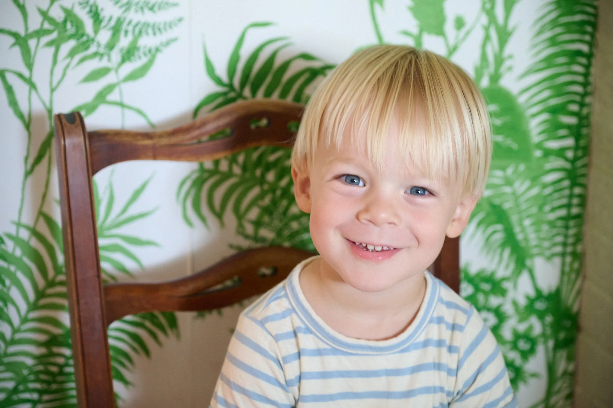 Young boy smiles at a family reunion in Westport, CT with extended family photographer Pamela Einarsen.