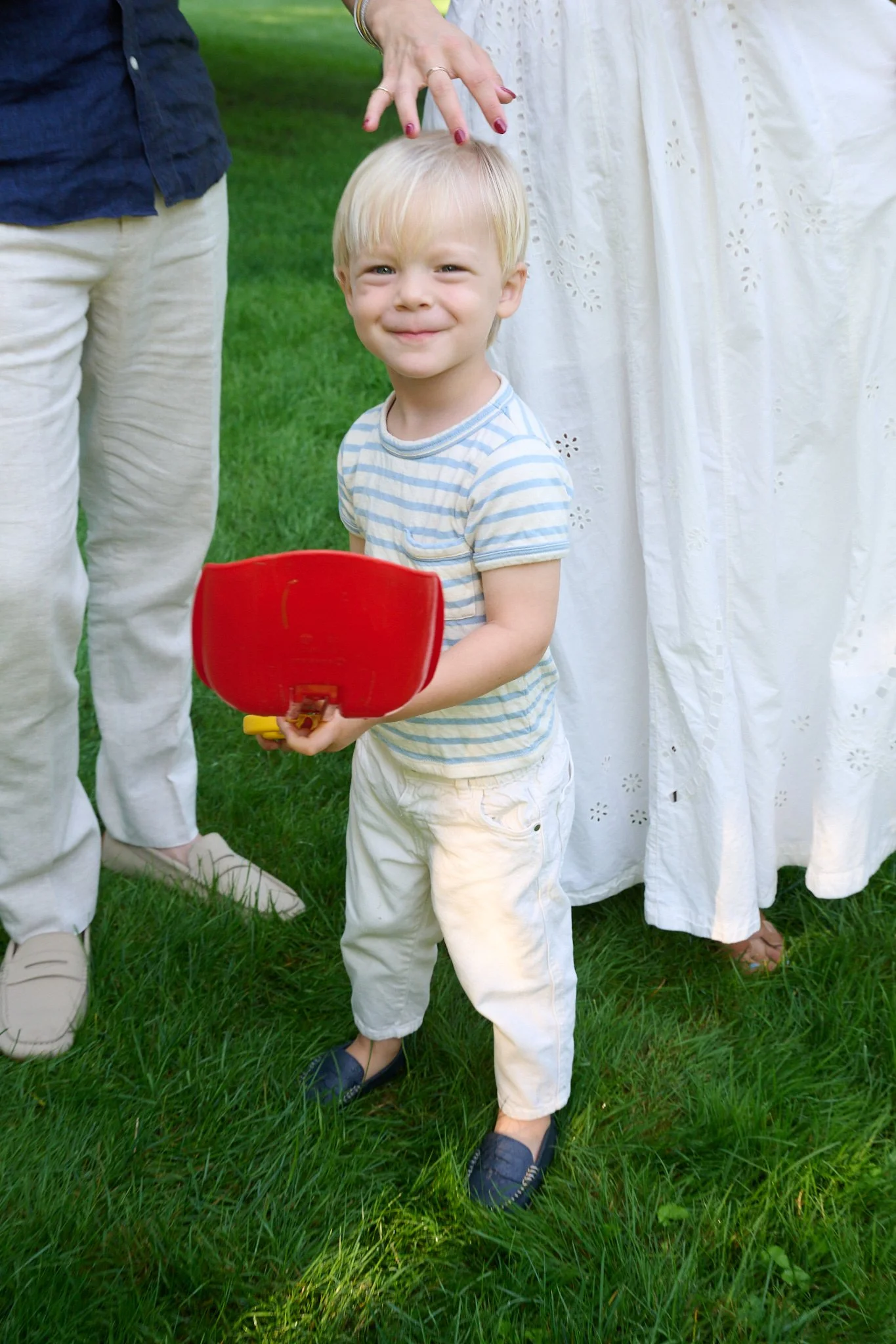 Toddler smiles with his shovel by familyphotographer Pamela Einarsen in Westport CT