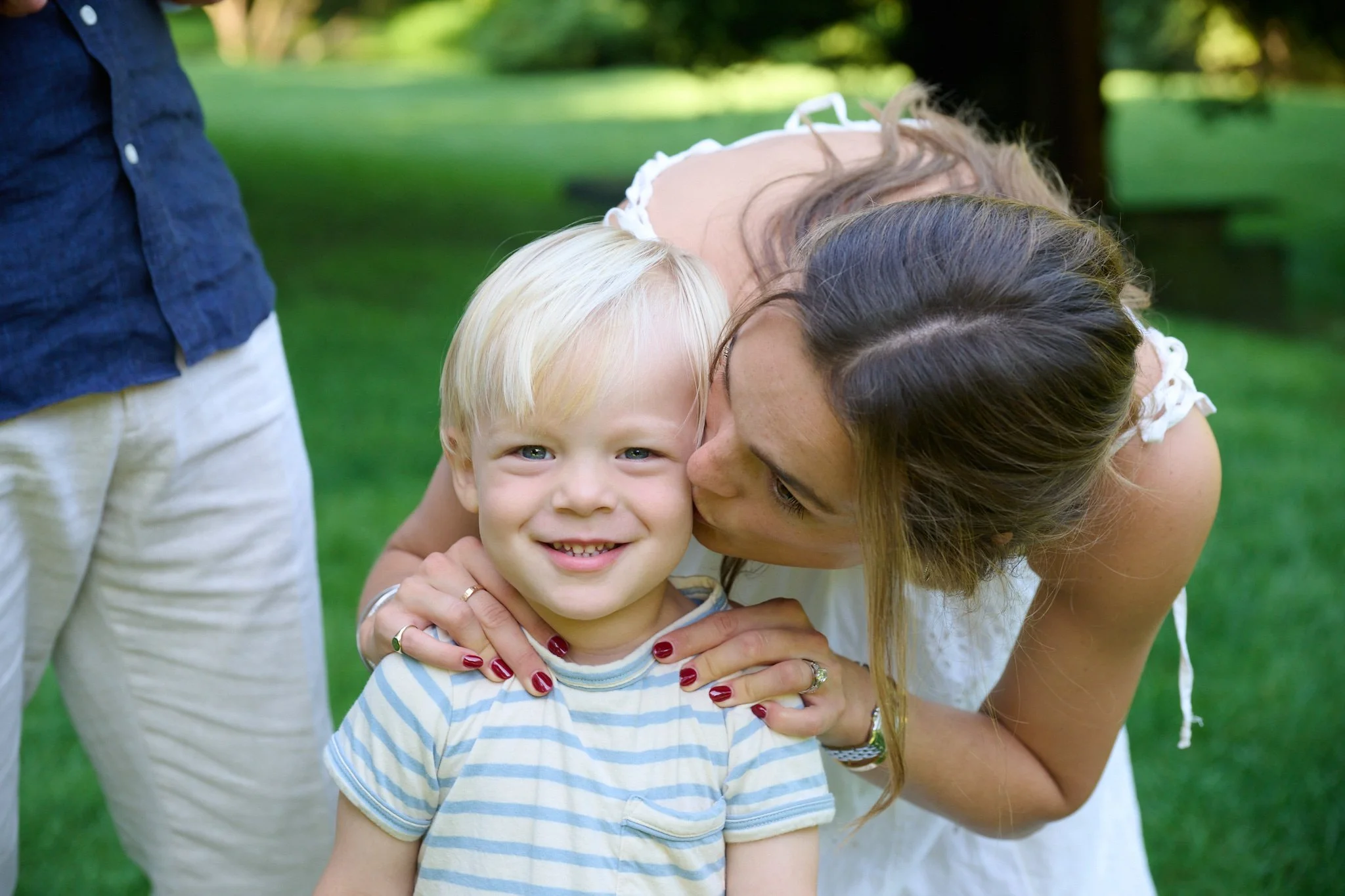 Mom kisses her toddler son in Westport CT family photography session with family photographer Pamela Einarsen.