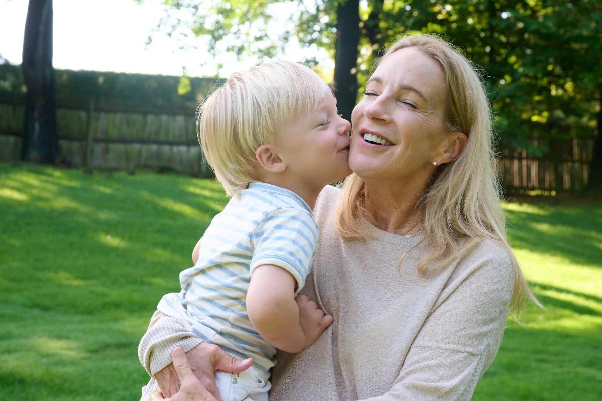 Toddler kisses his grandmother in Westport CT photo session with family photographer Pamela Einarsen.