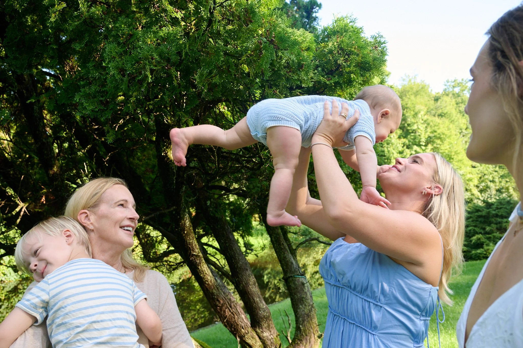 Aunt and grandmother play with their grandsons and nephews at Westport CT house by family photographer Pamela Einarsen.
