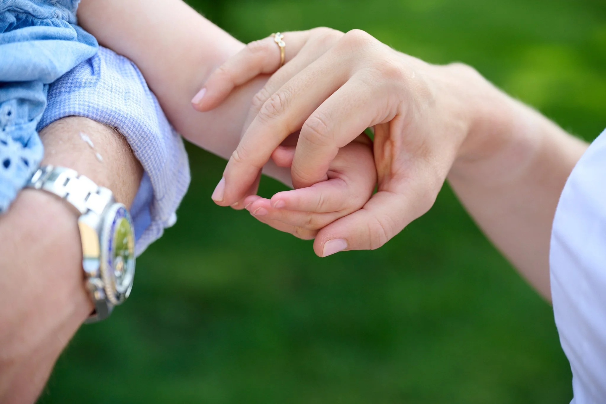 Mom holds hand of her baby girl in Westport, CT by family photographer Pamela Einarsen.