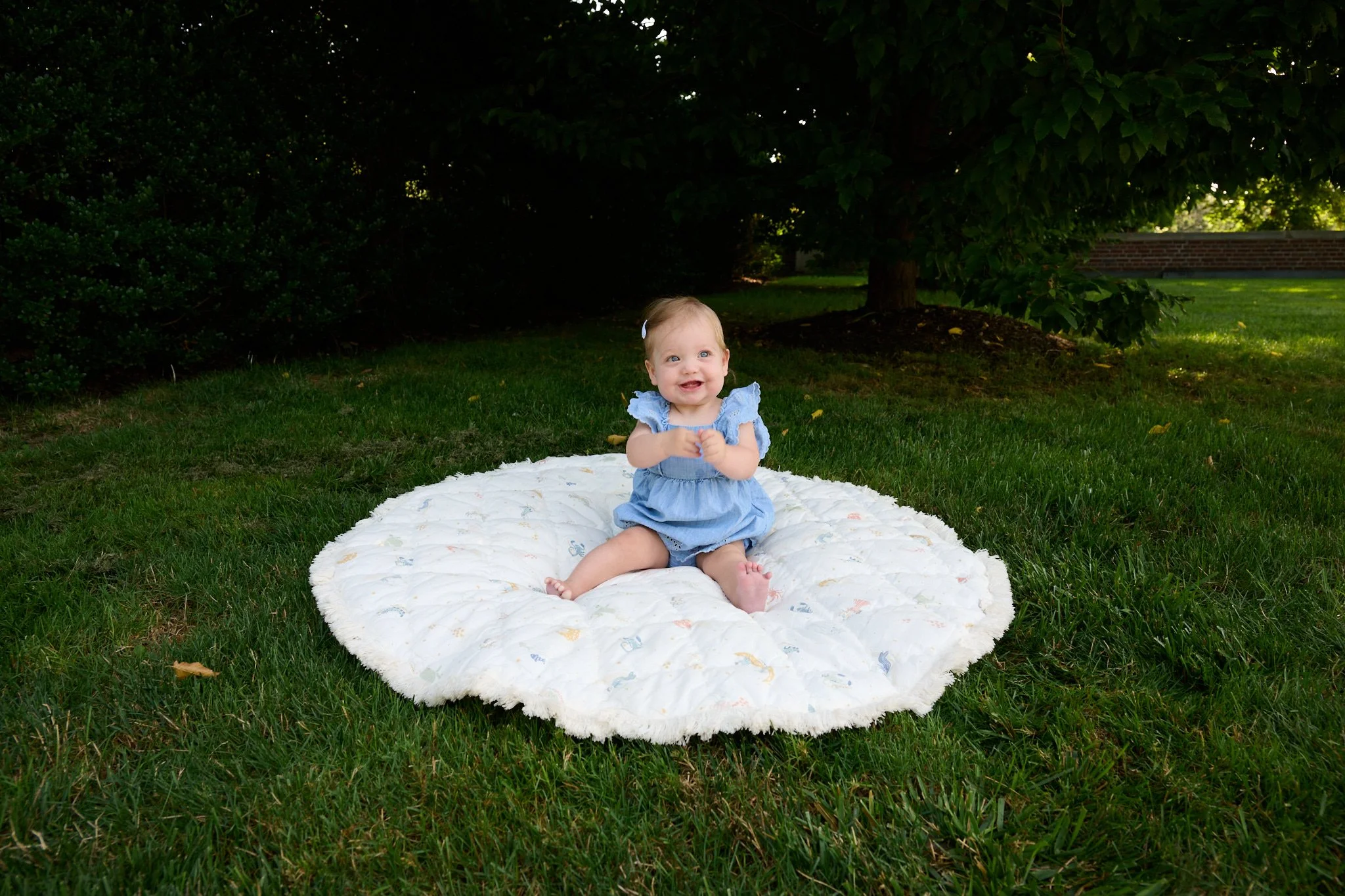 Baby laughs on blanket at her Westport CT home by family photographer Pamela Einarsen.