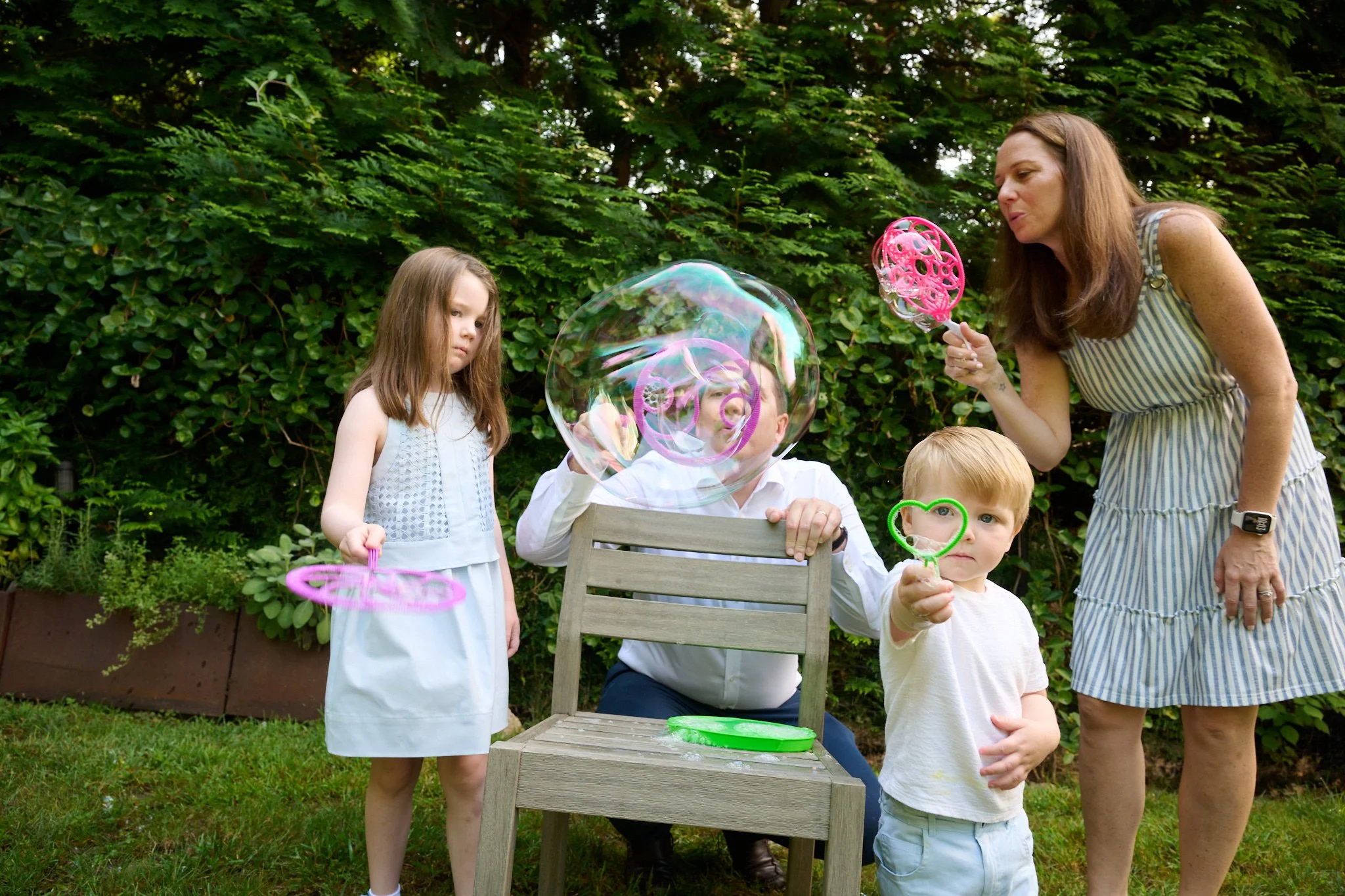 Westport CT family blows bubbles for lifestyle photographer Pamela Einarsen.