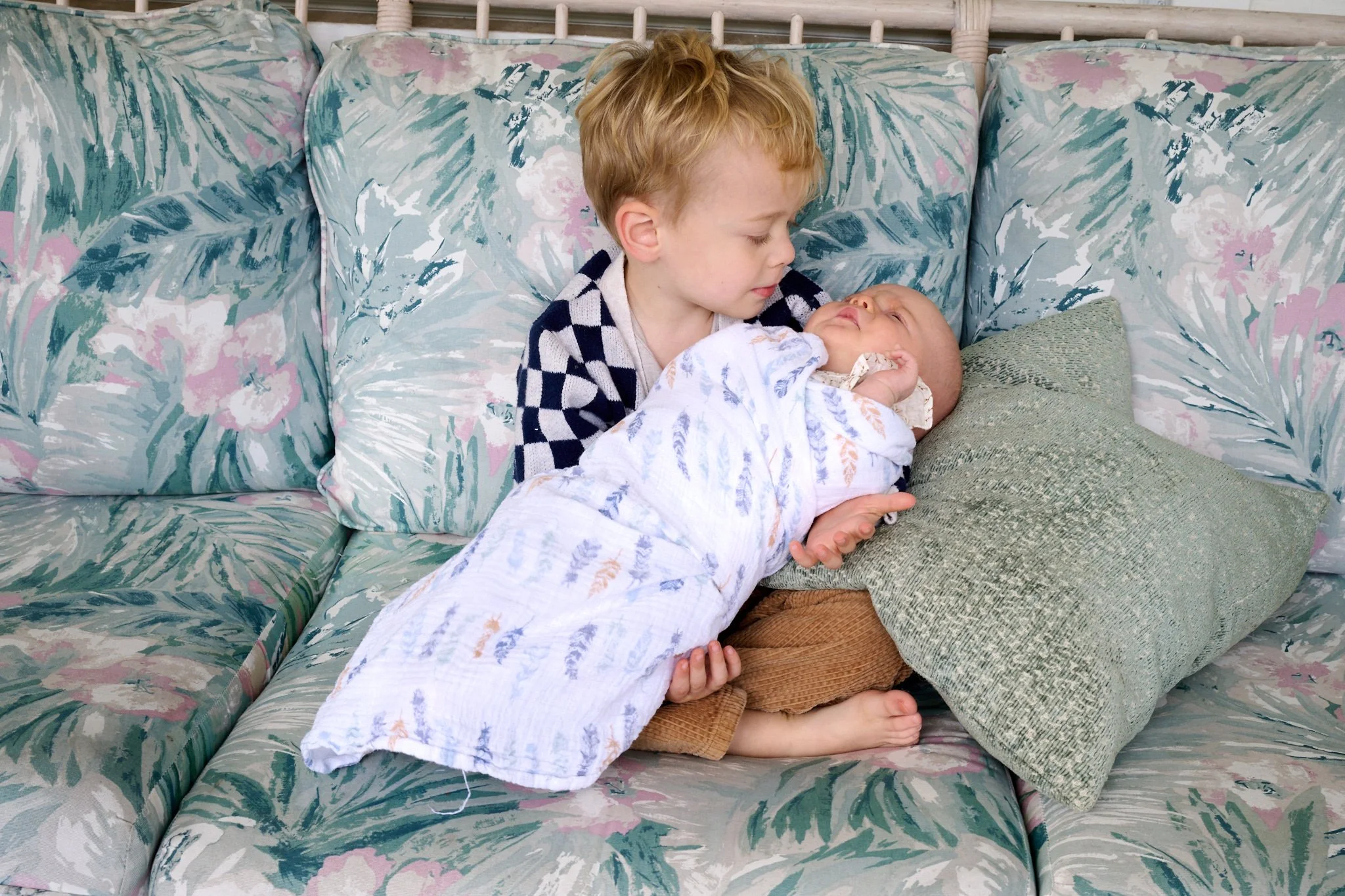 Young boy carefully holds his newborn baby sister in West Hartford, CT by family photographer Pamela Einarsen. 