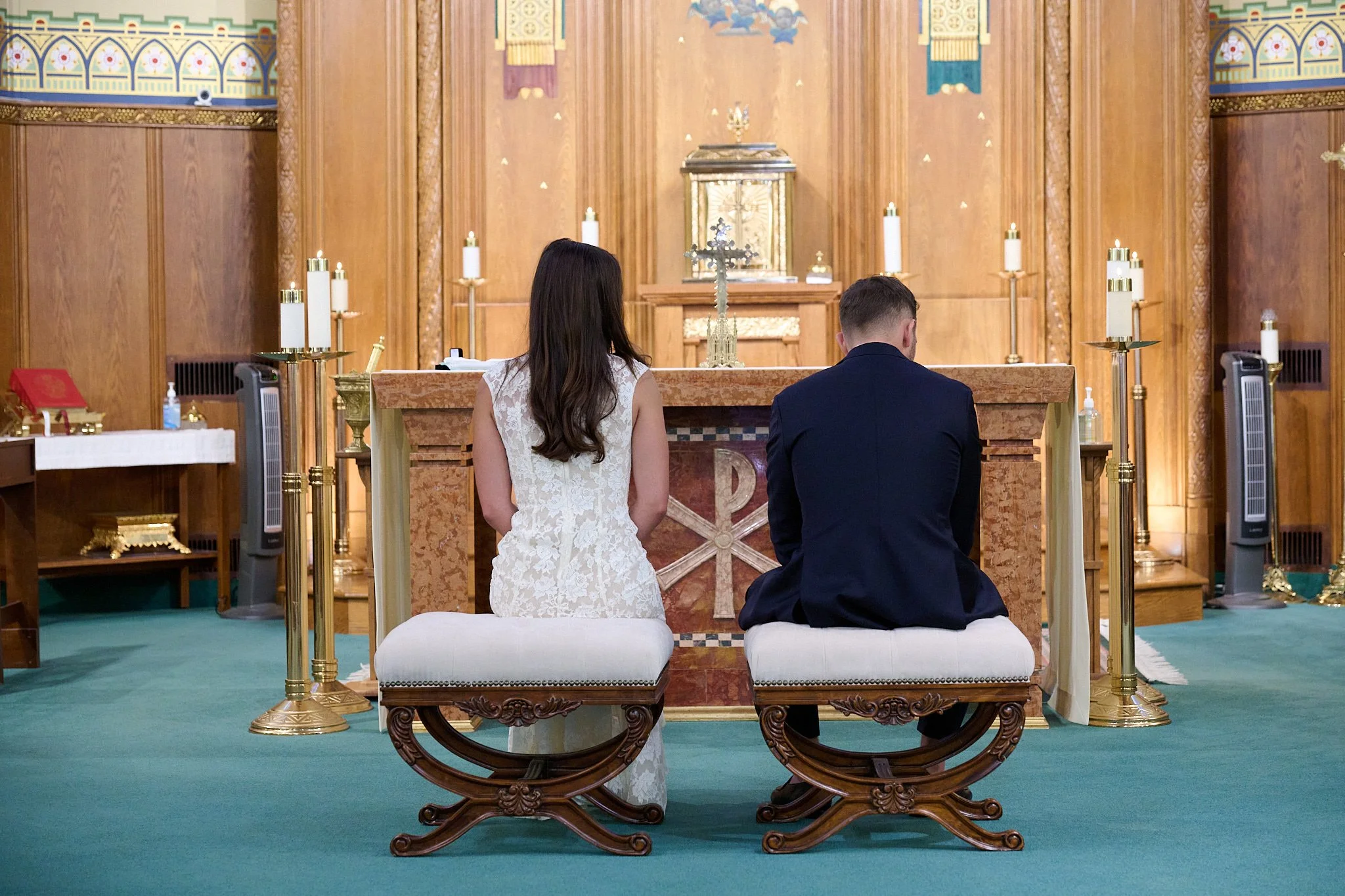 Bride and Groom sit at the altar of Church of Assumption in Westport, CT by wedding photographer Pamela Einarsen. 