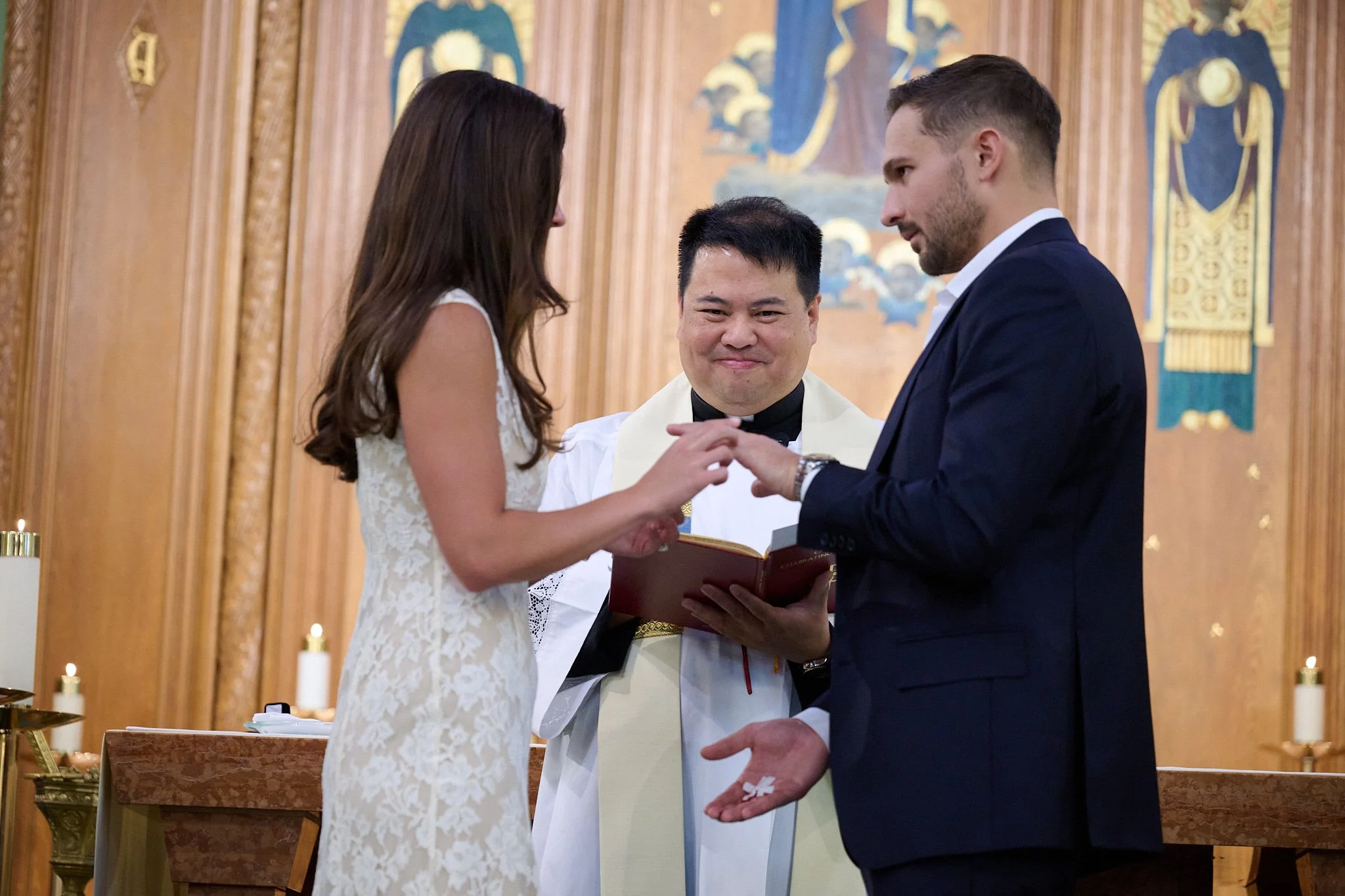 Bride and groom exchange rings at wedding in Westport, CT by event photographer Pamela Einarsen.