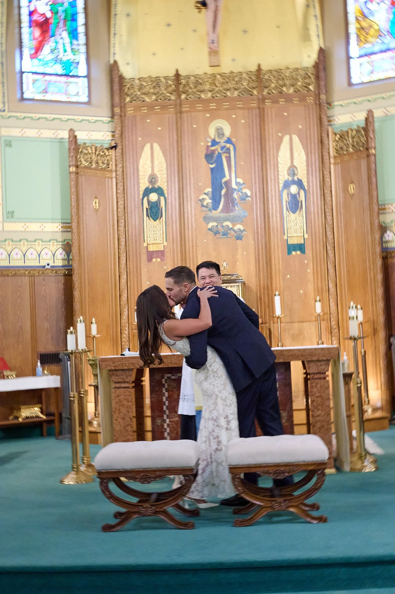Bride and groom kiss after getting married at Church of the Assumption in Westport, CT by wedding photographer Pamela Einarsen. 