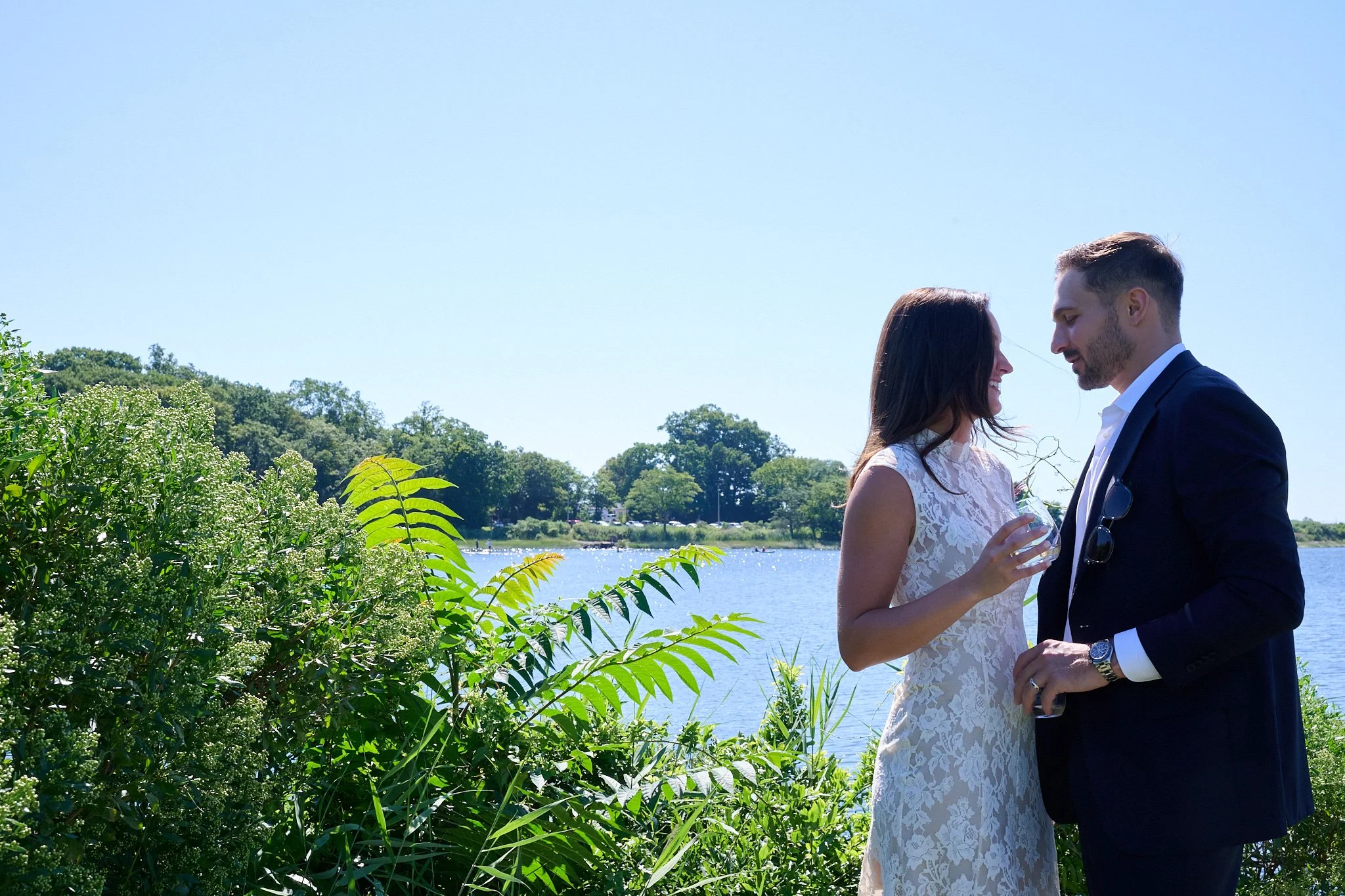 Bride and groom stand by the water in Westport CT after their wedding by photographer Pamela Einarsen. 