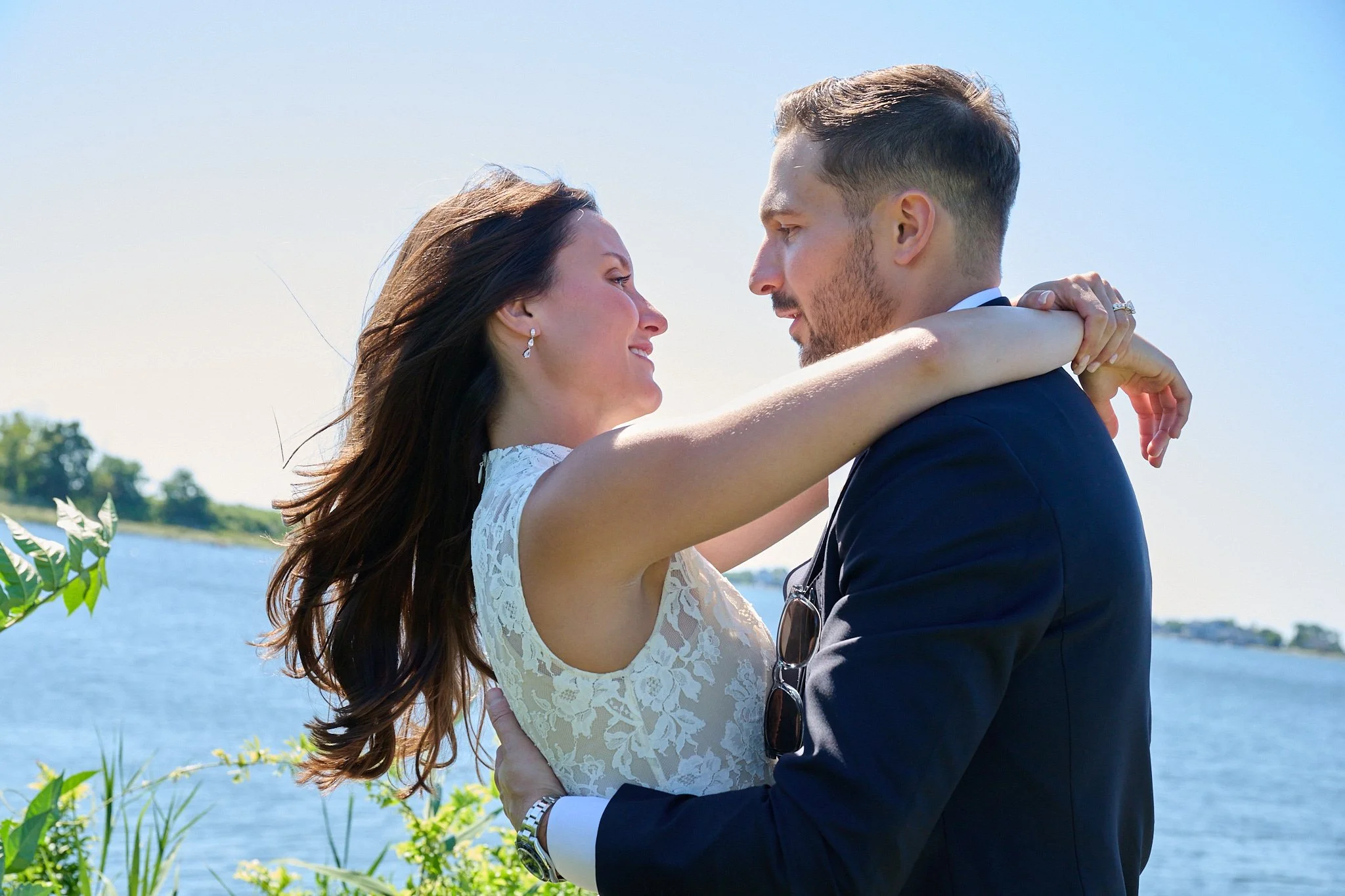 Bride and groom hug on lawn in Westport, CT with wedding photographer Pamela Einarsen.