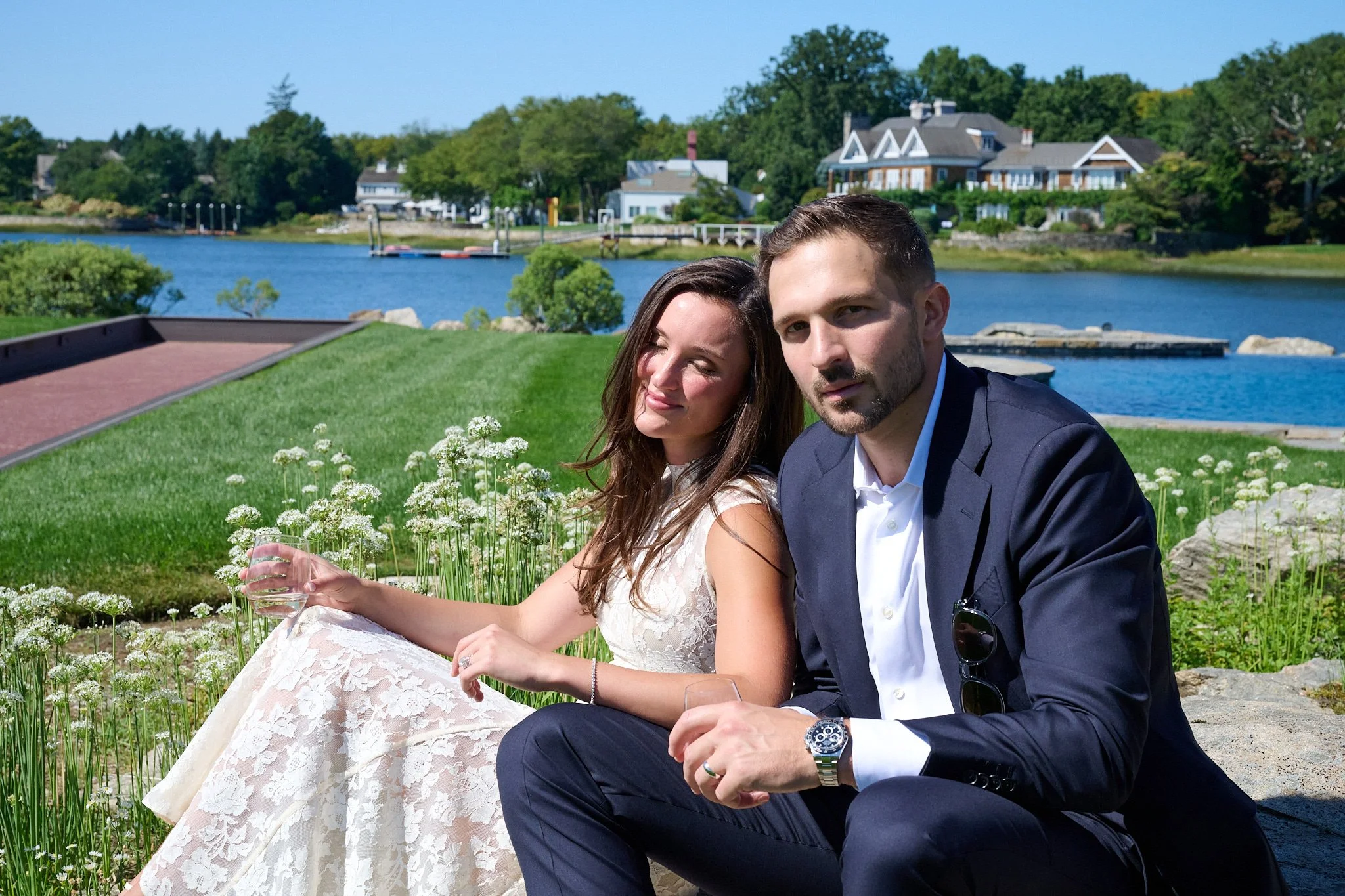 Bride and groom relax at a Westport, CT home by the water by wedding photographer Pamela Einarsen. 