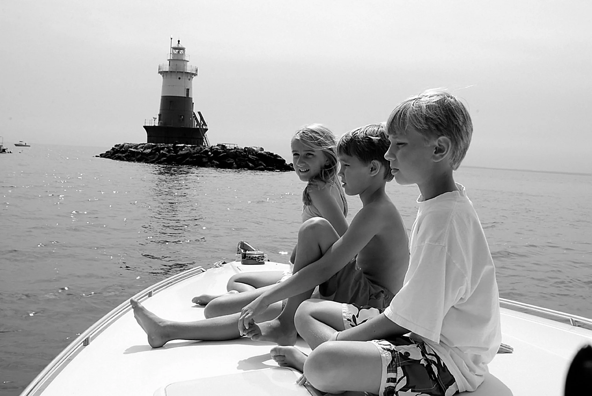 Children ride a small boat near Pear Tree Point, Darien — one of the towns Pamela Einarsen photographs across Fairfield County