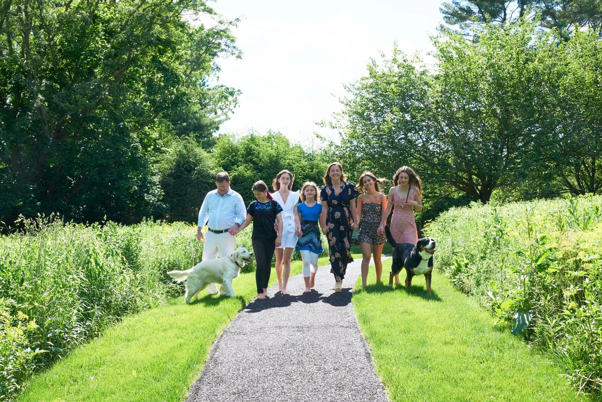 Family walks along a nature path at a family photo session with Pamela Einarsen in New Canaan.