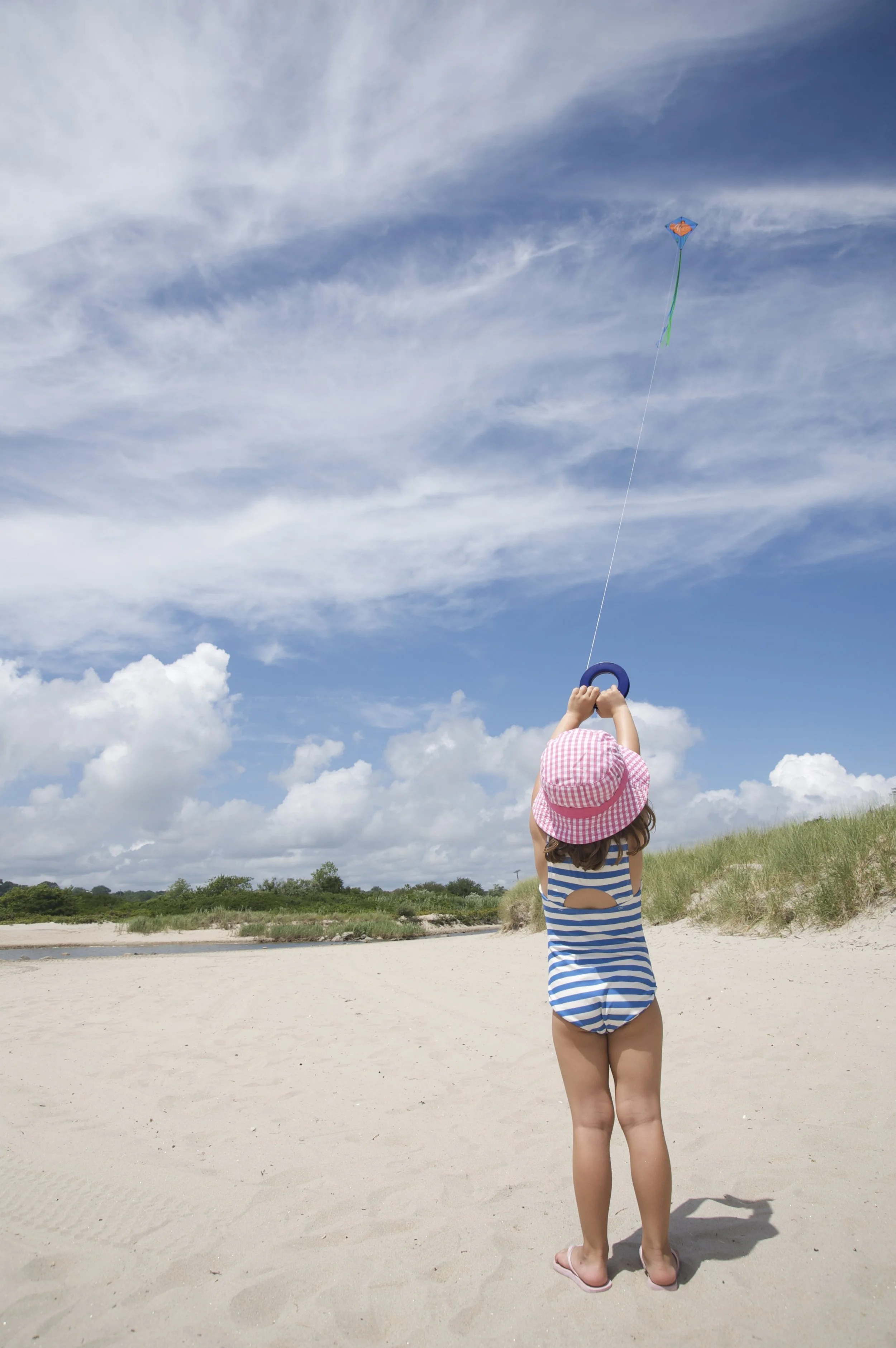 girl flys kite on Naragansett beach