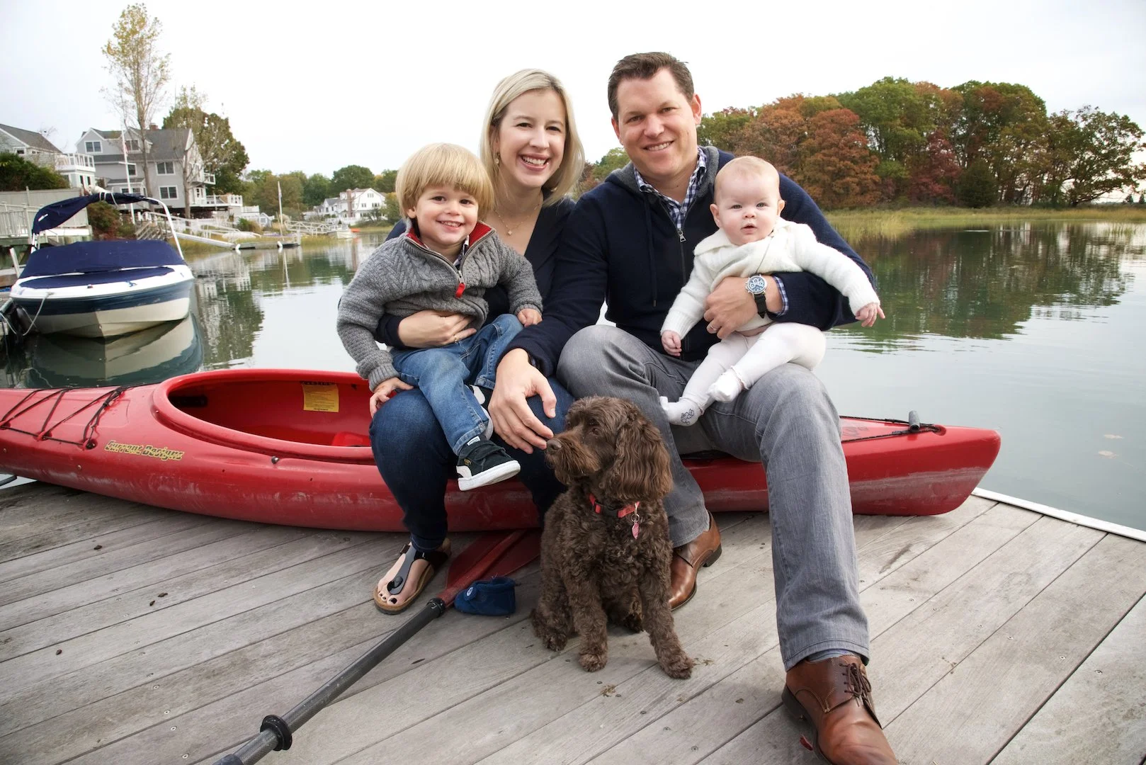 Family with young kids and dog sit on a kayak in Rowayton