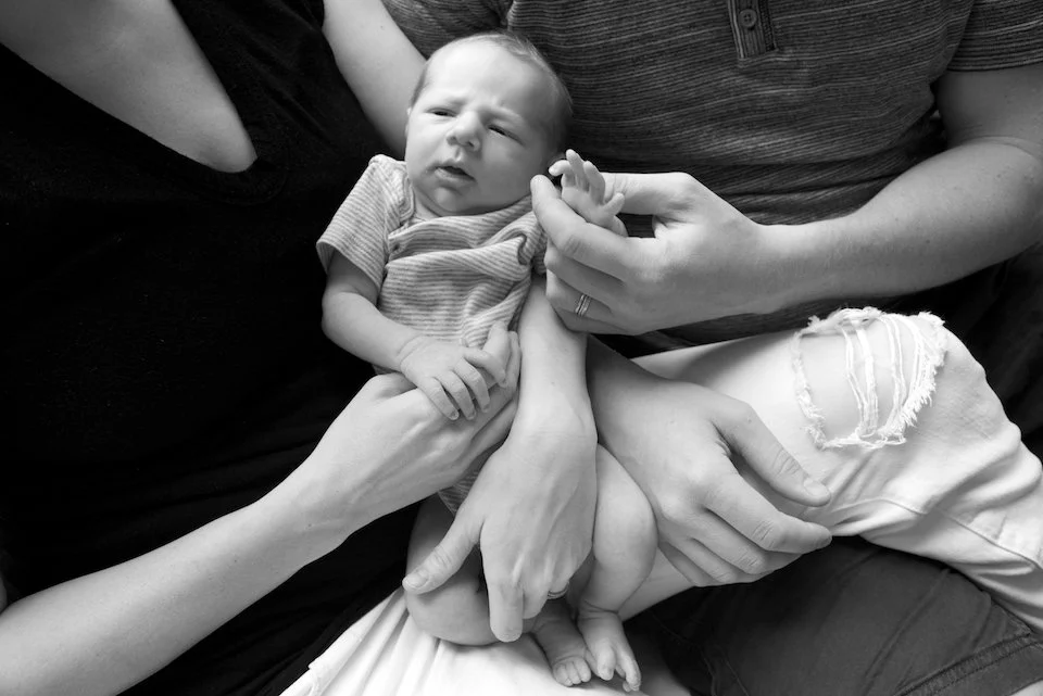 B&W baby being held at Easton family lifestyle session by photographer Pamela Einarsen