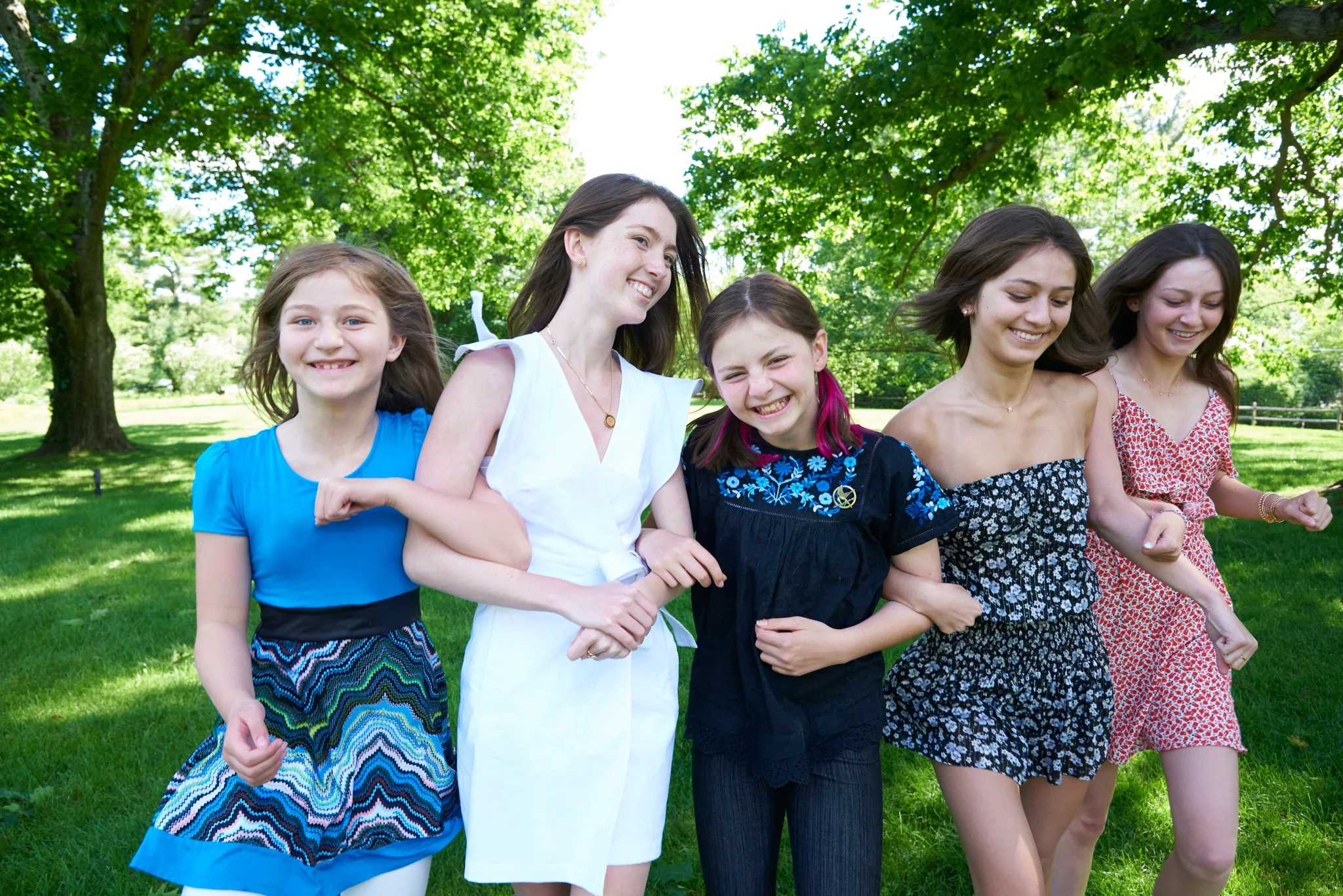 Family of girls walk arm and arm in New Caanan, CT lifestyle photo session with photographer Pamela Einarsen