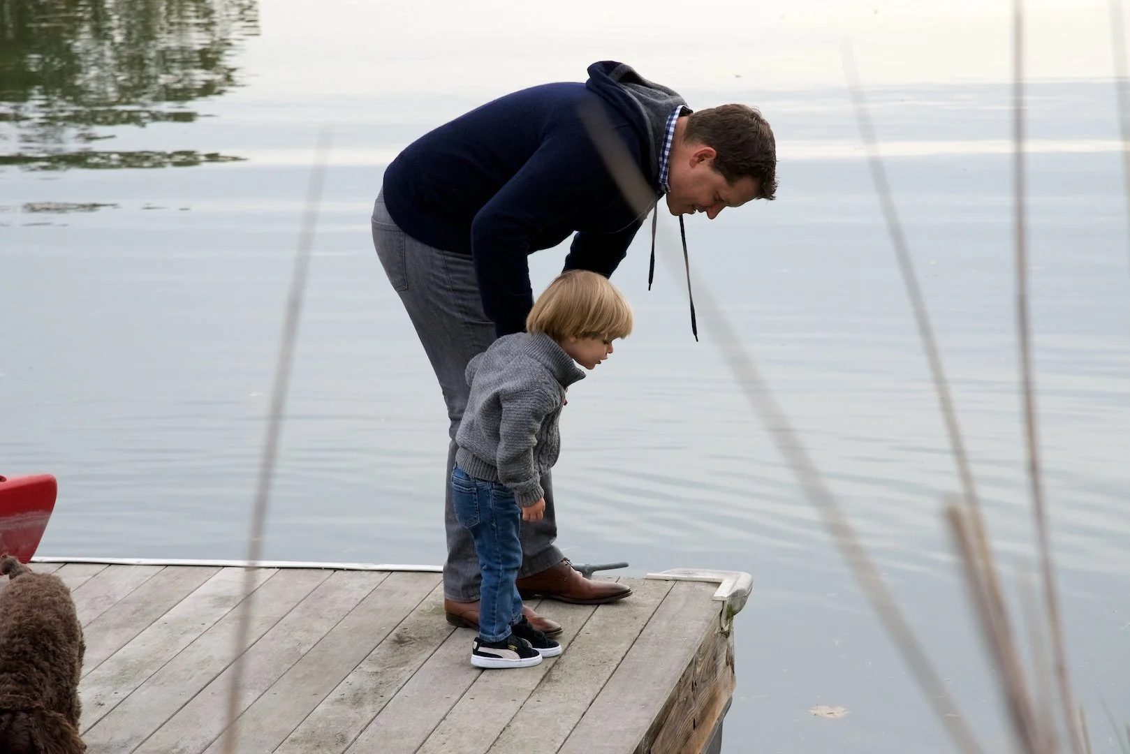Father and child at the water's edge in Rowayton — one of the towns Pamela Einarsen photographs across Fairfield County