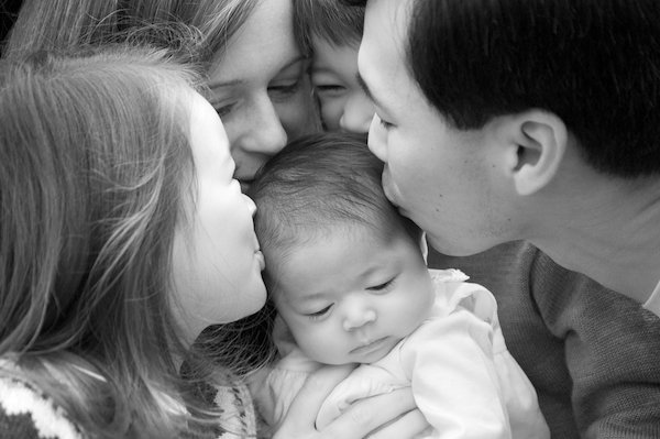 Parents hold their baby close in a family portrait, Ridgefield — one of the towns Pamela Einarsen photographs across Fairfield County
