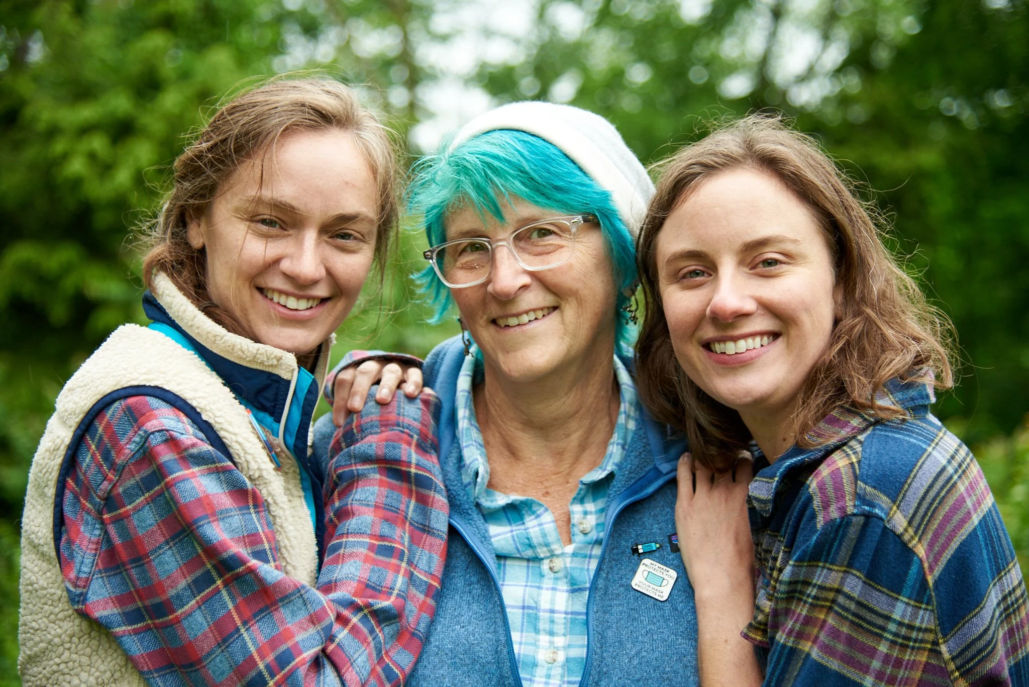 Mother smiles with daughters in her Weston yard by lifestyle photographer