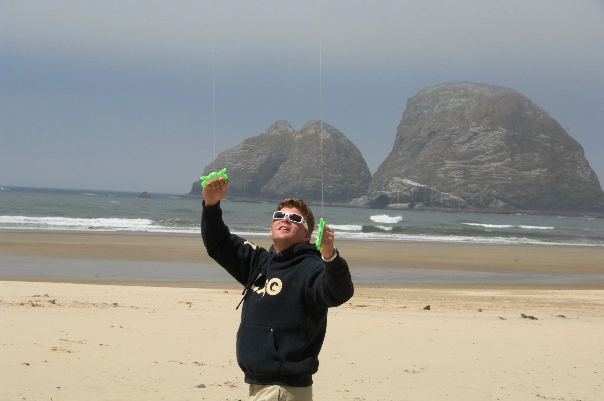 Boy flies kite at Haystack Rock in Oregon