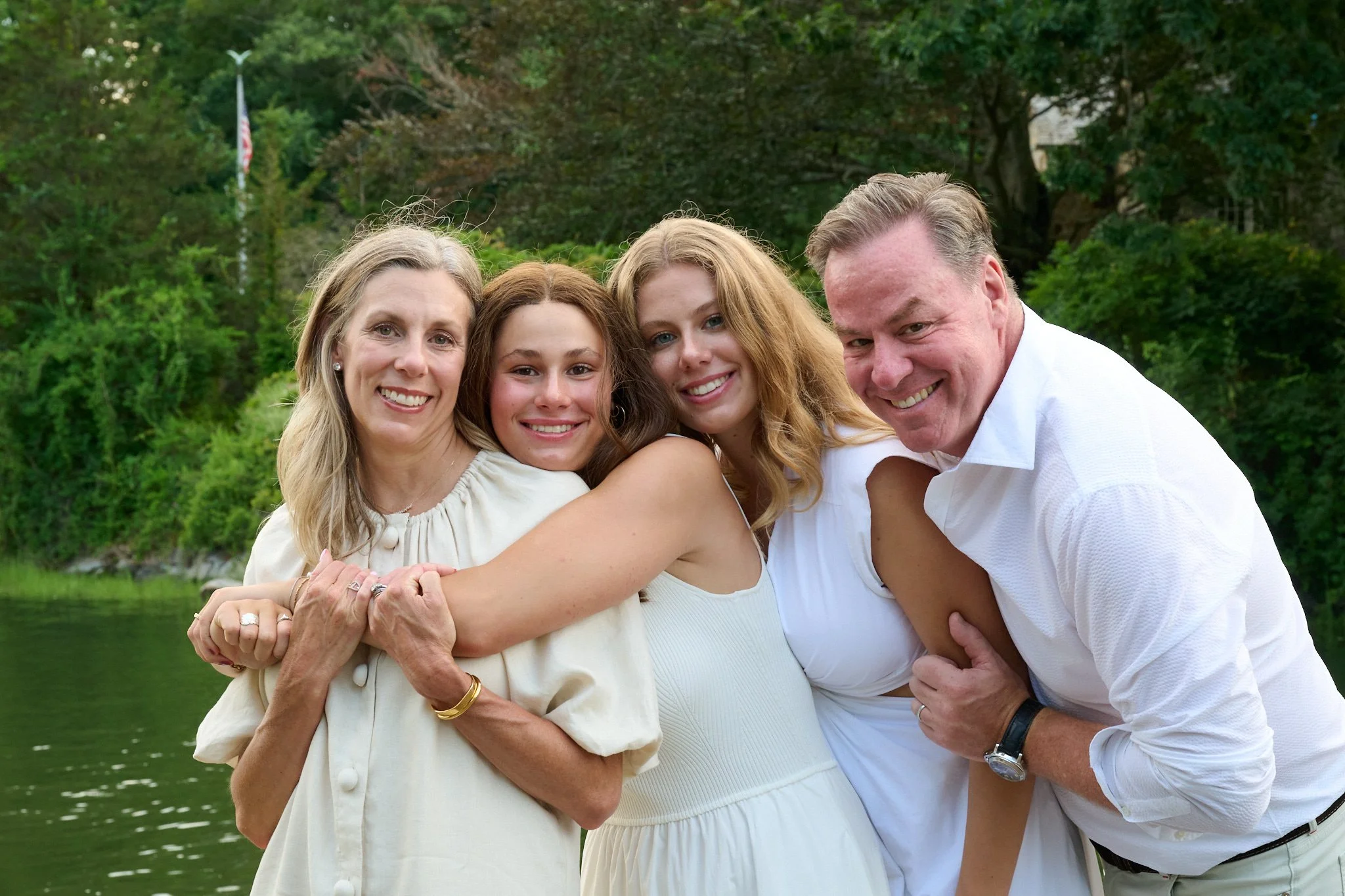 Family hugs by the water in Tokeneke, Darien, CT