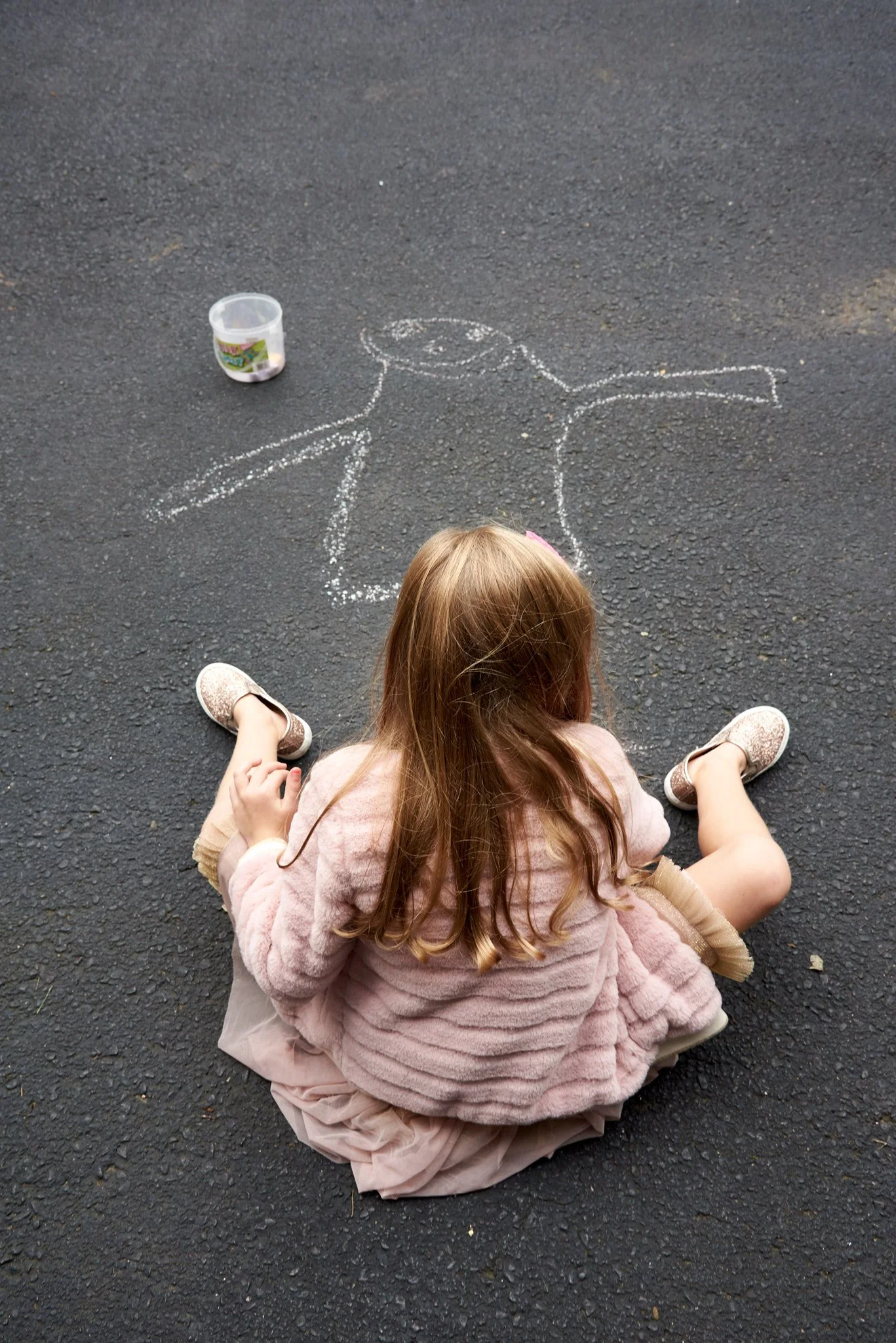 Girl draws on her Fairfield, CT driveway.