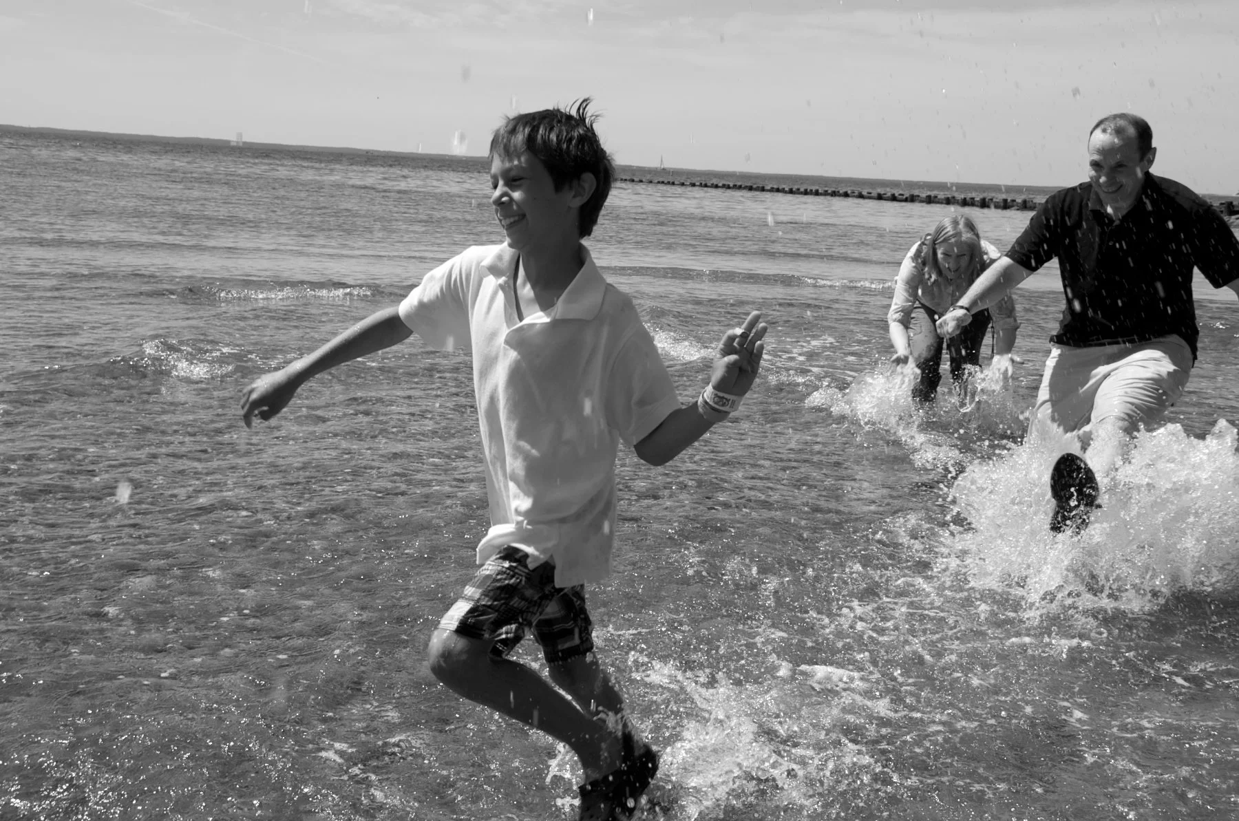 Family in Compo Beach water in Westport, CT with photographer Pamela Einarsen